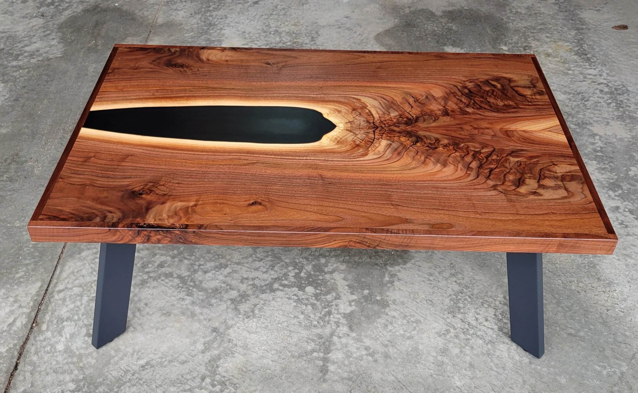 bookmatched walnut and epoxy coffee table with metal legs