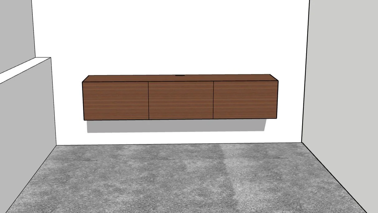 A wooden floating cabinet mounted on a white wall in a room with gray carpet.