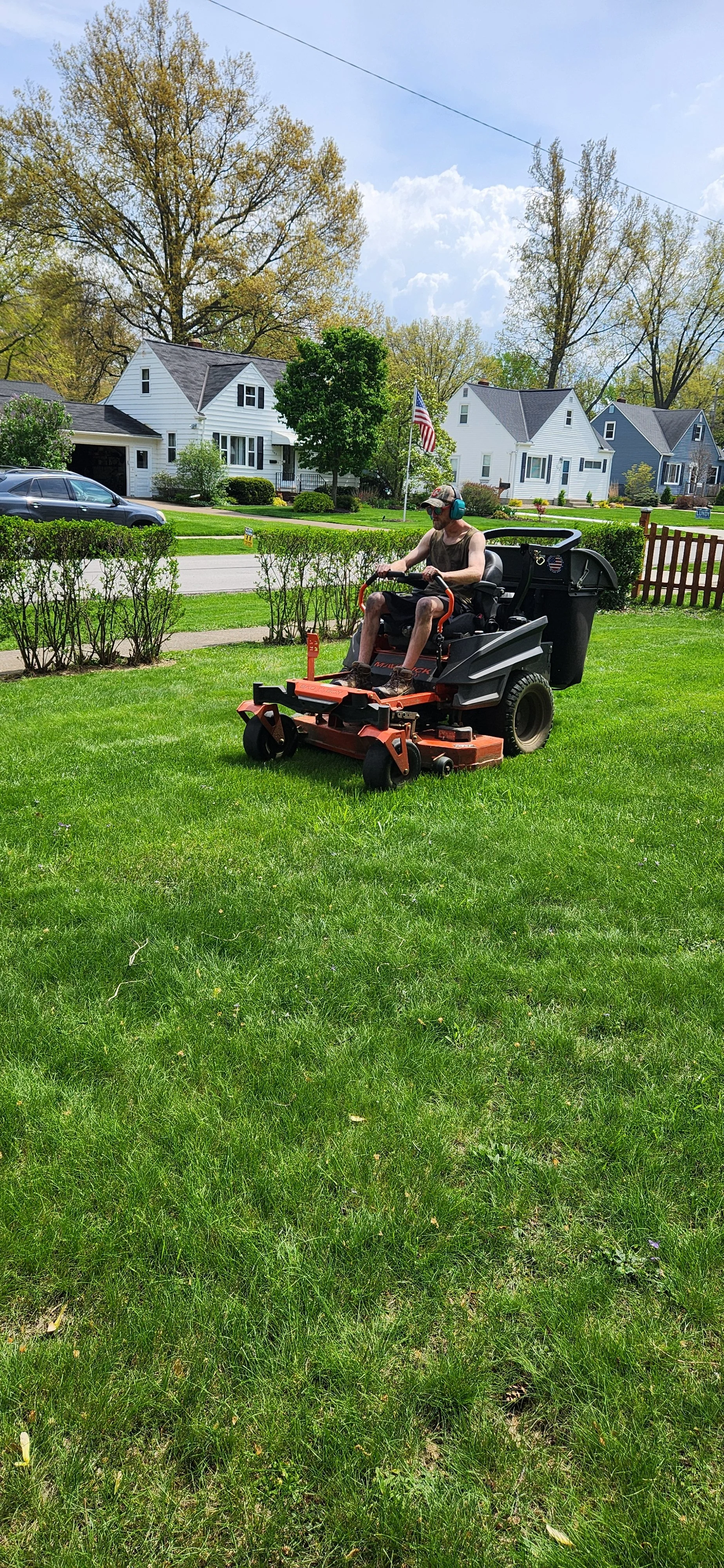King Cut crew mowing a residential lawn during recurring lawn maintenance