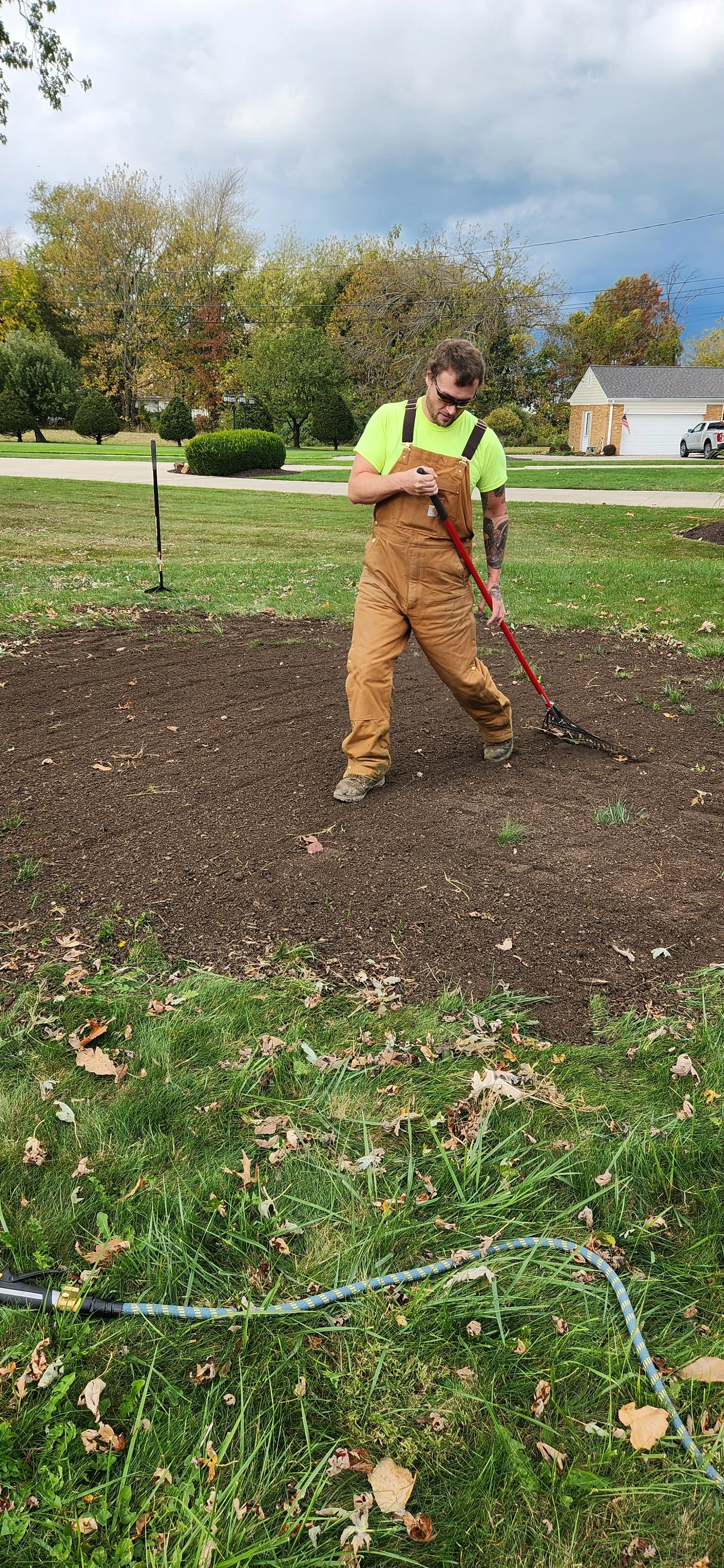 King Cut crew performing turf improvement work on a residential lawn