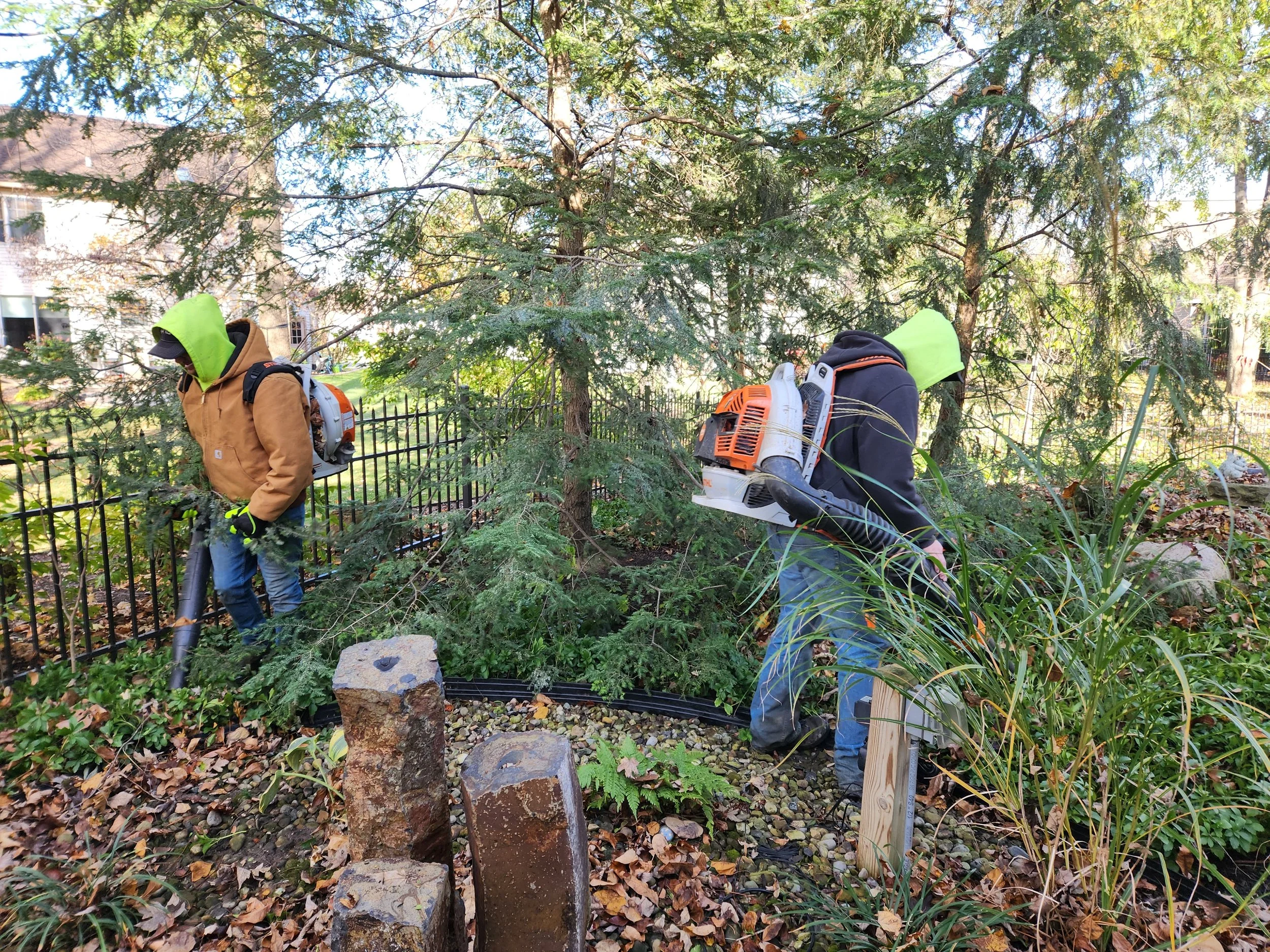 King Cut crew performing detailed fall cleanup around landscape beds