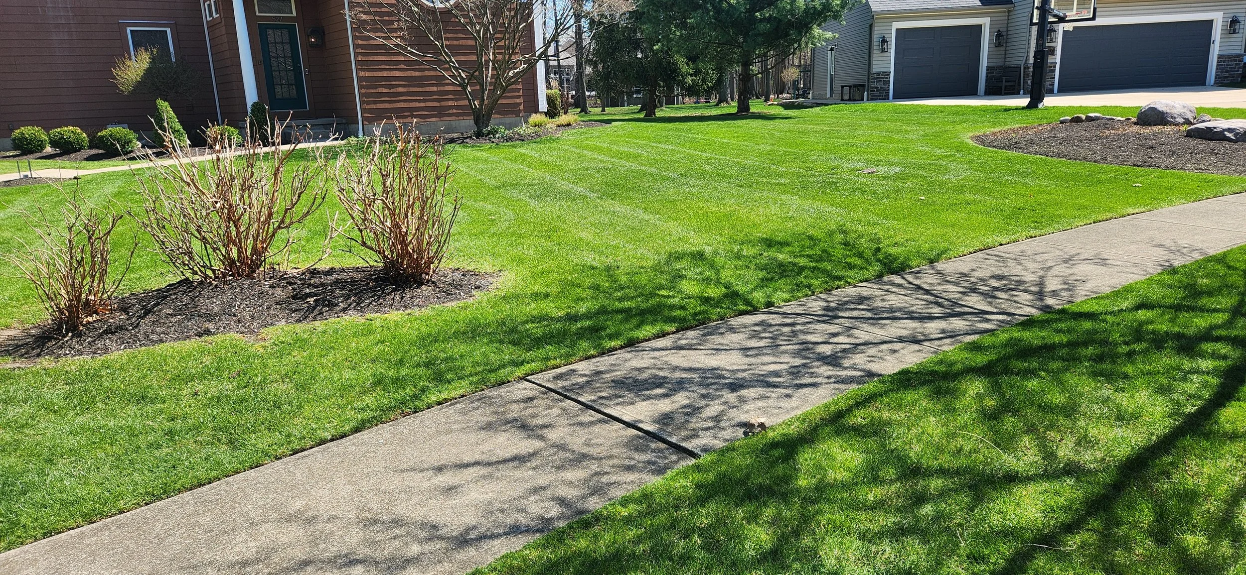 Residential property maintained through ongoing seasonal cleanup care