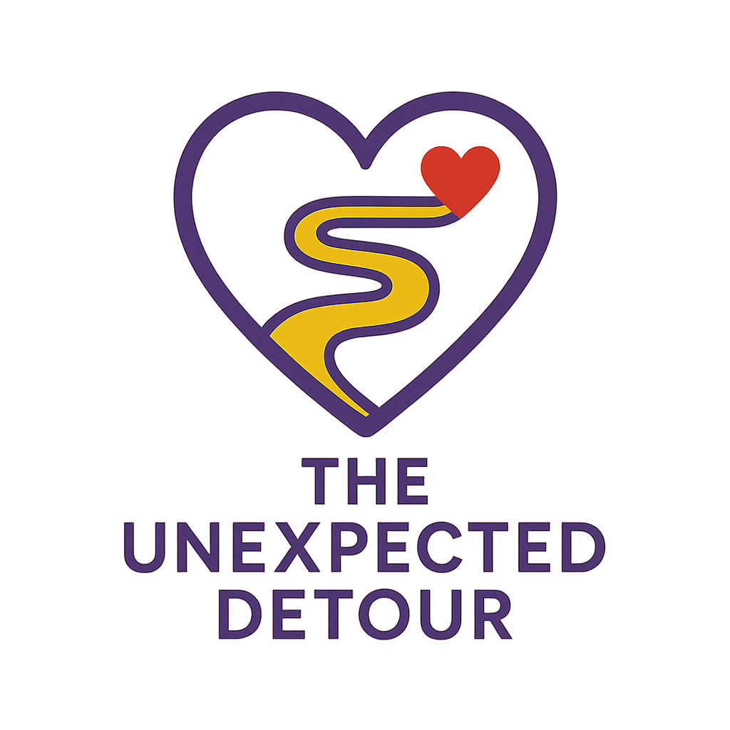 A purple heart-shaped logo with a yellow winding road inside, ending in a red heart, and the text "The Unexpected Detour" below.