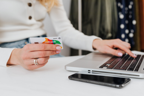 Woman holding a credit card completing an online payment
