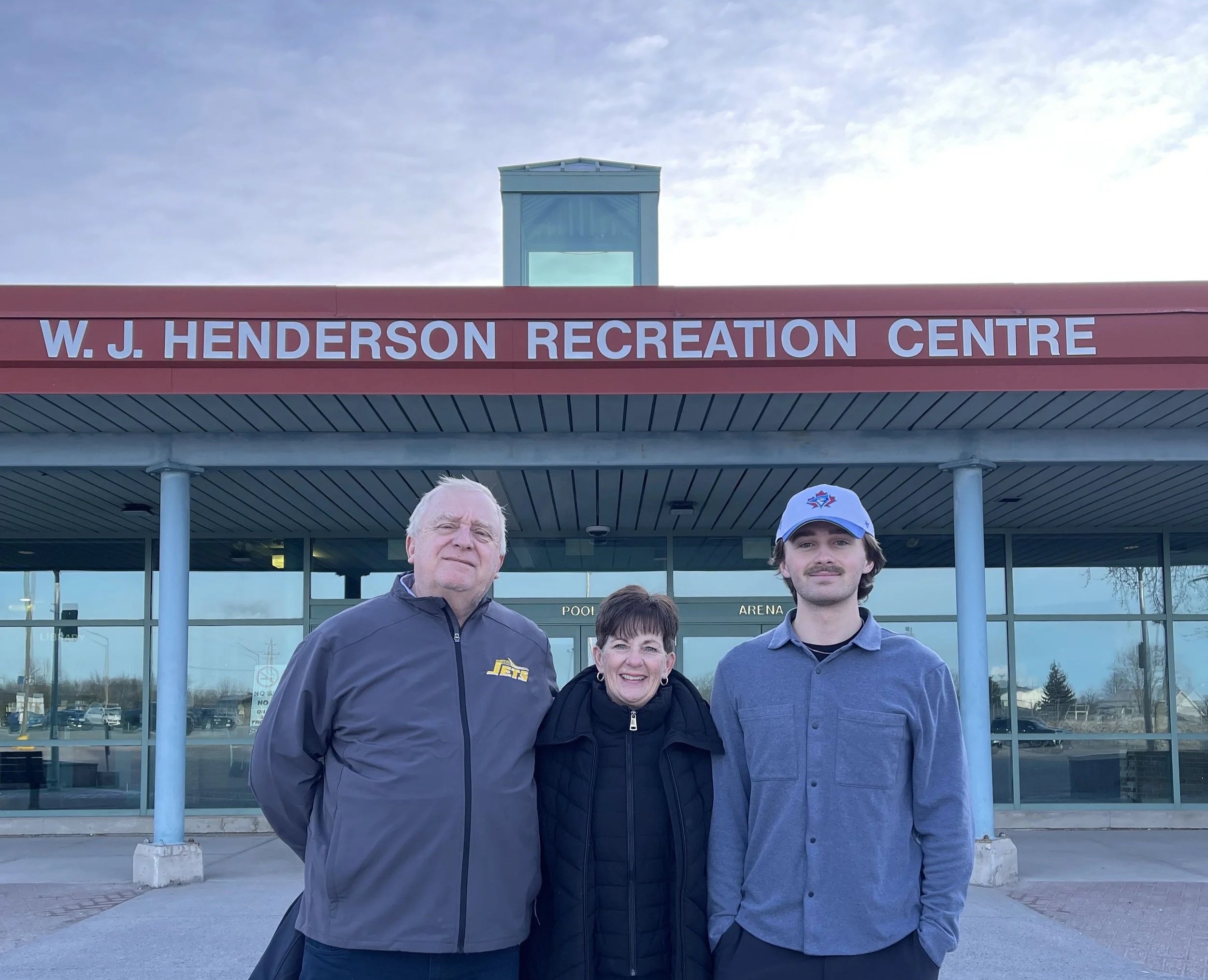 Proderick family standing in front of the W.J. Henderson Community Centre