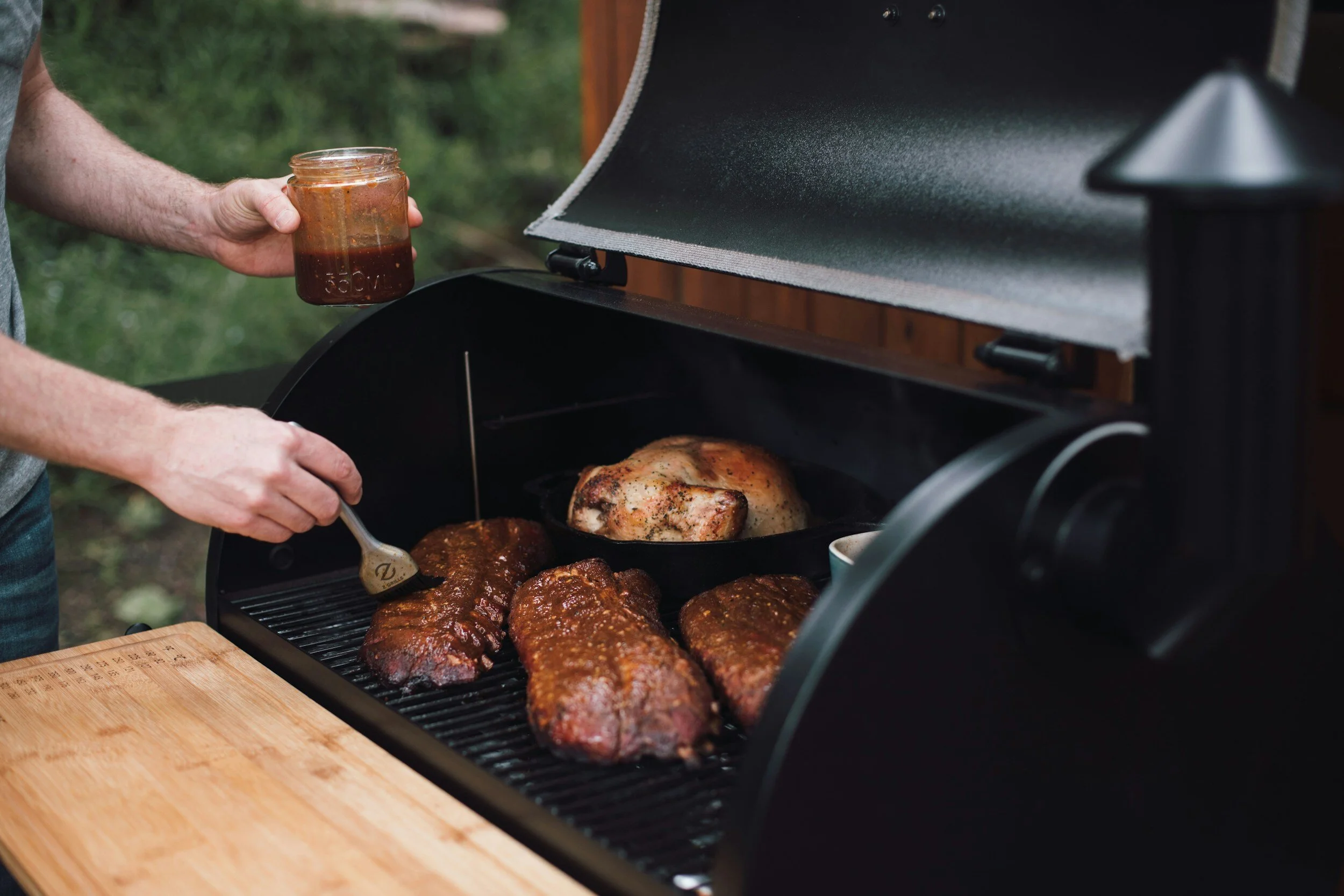 Pellet smoker with the lid open cooking low and slow BBQ
