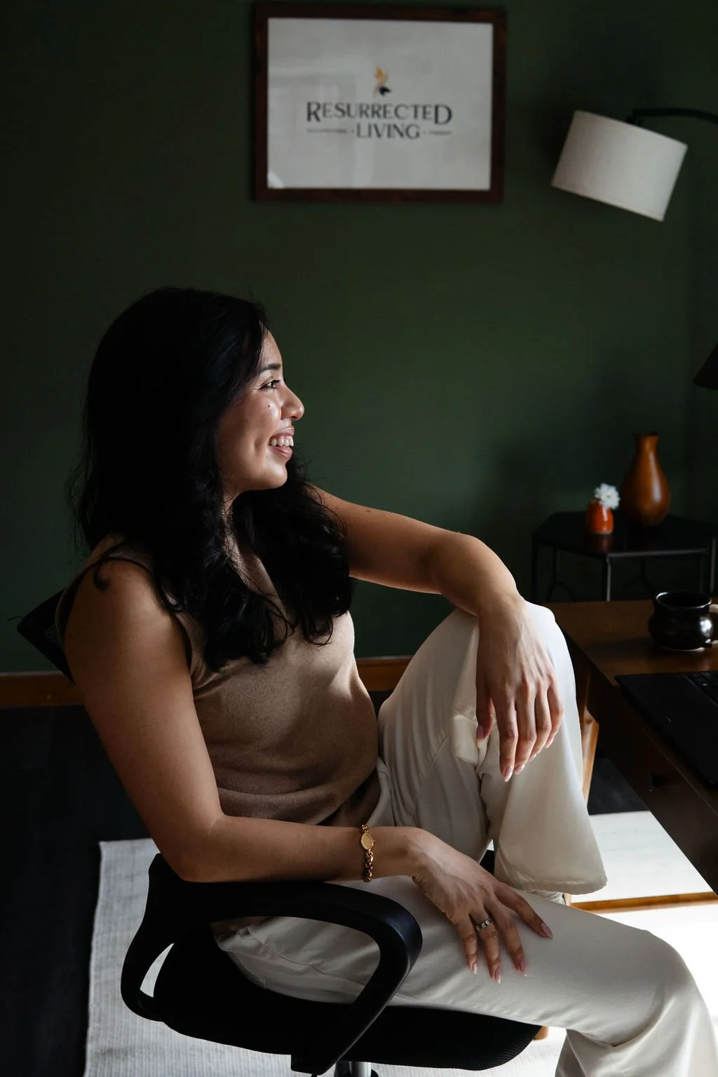 Stephanie Poma, OTR/L and founder of Resurrected Living, seated warmly in her office inviting practitioners and referral partners to collaborate in supporting trauma survivors toward fully living