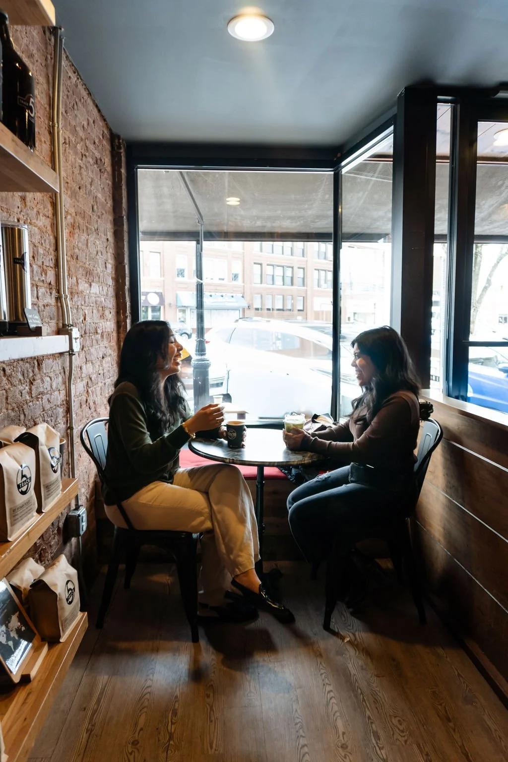 Stephanie Poma, founder of Resurrected Living, meeting with a client over coffee, representing the warm and personal connection she brings to every discovery call