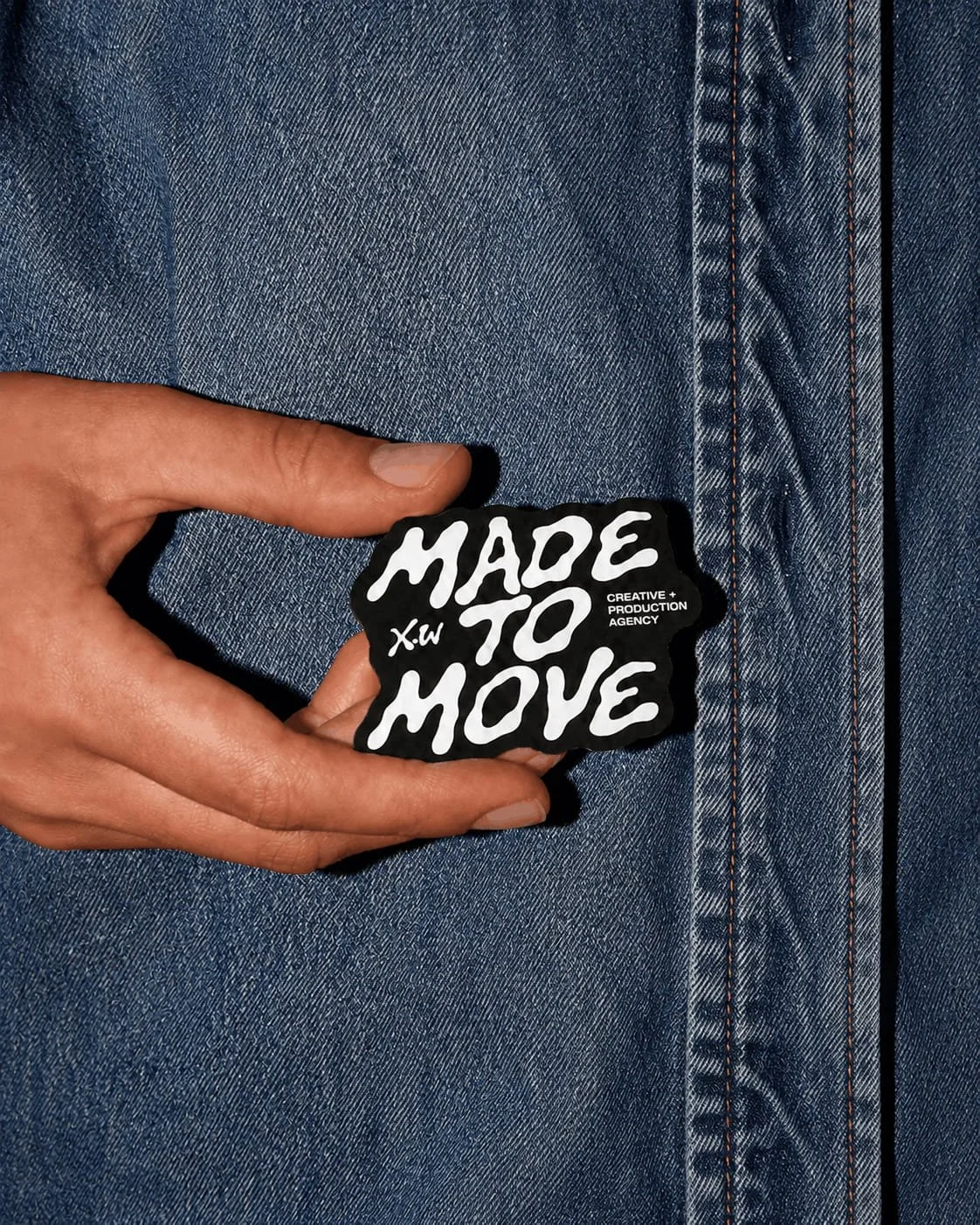 Custom brand sticker showcasing playful typography and branded merchandise created for a creative and production agency.