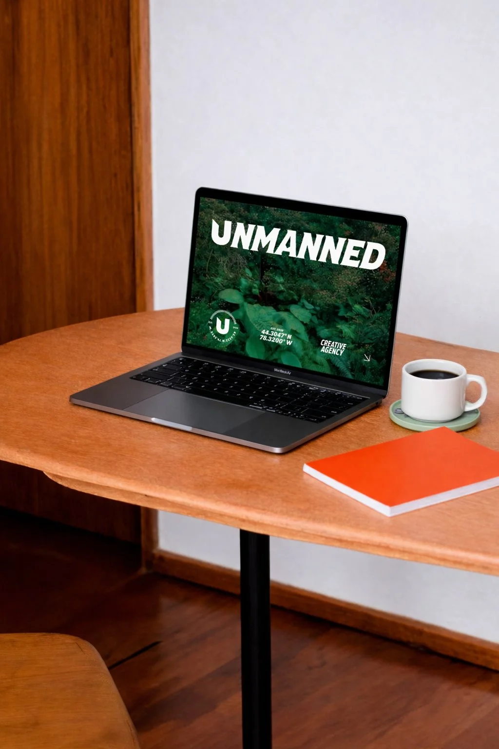 Laptop displaying the homepage of a creative marketing agency website, showcasing the brand identity and responsive web design in a modern workspace.