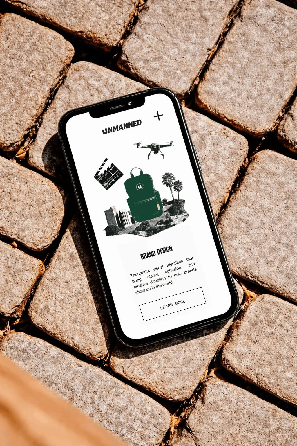 Mobile website design for a creative marketing agency displayed on a smartphone, highlighting brand design services with custom illustrations and a responsive user interface.