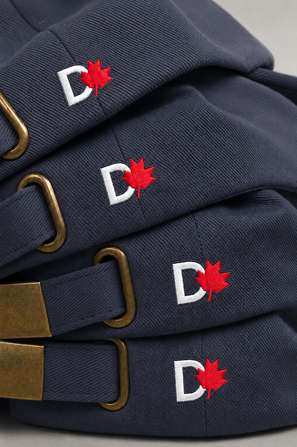 Navy blue hats embroidered with the Dyslexia Canada logo, designed as branded merchandise for staff, volunteers, and events.
