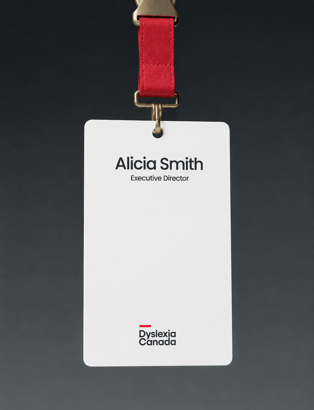 Branded staff name badge featuring the Dyslexia Canada visual identity with a red lanyard for employees and volunteers.
