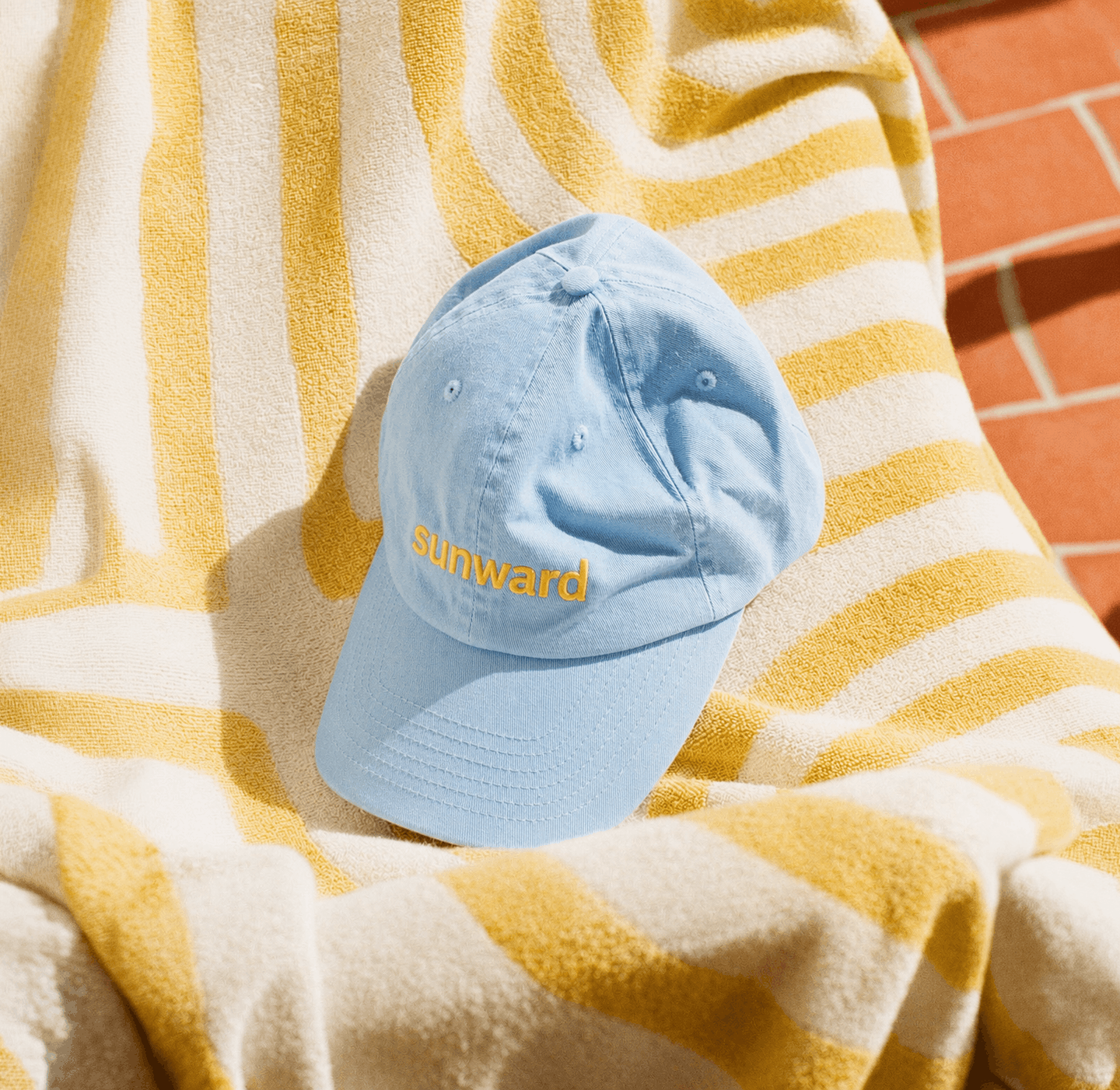 AI-generated brand merchandise mockup showcasing an embroidered cap as part of a premium AI-designed suncare brand identity.