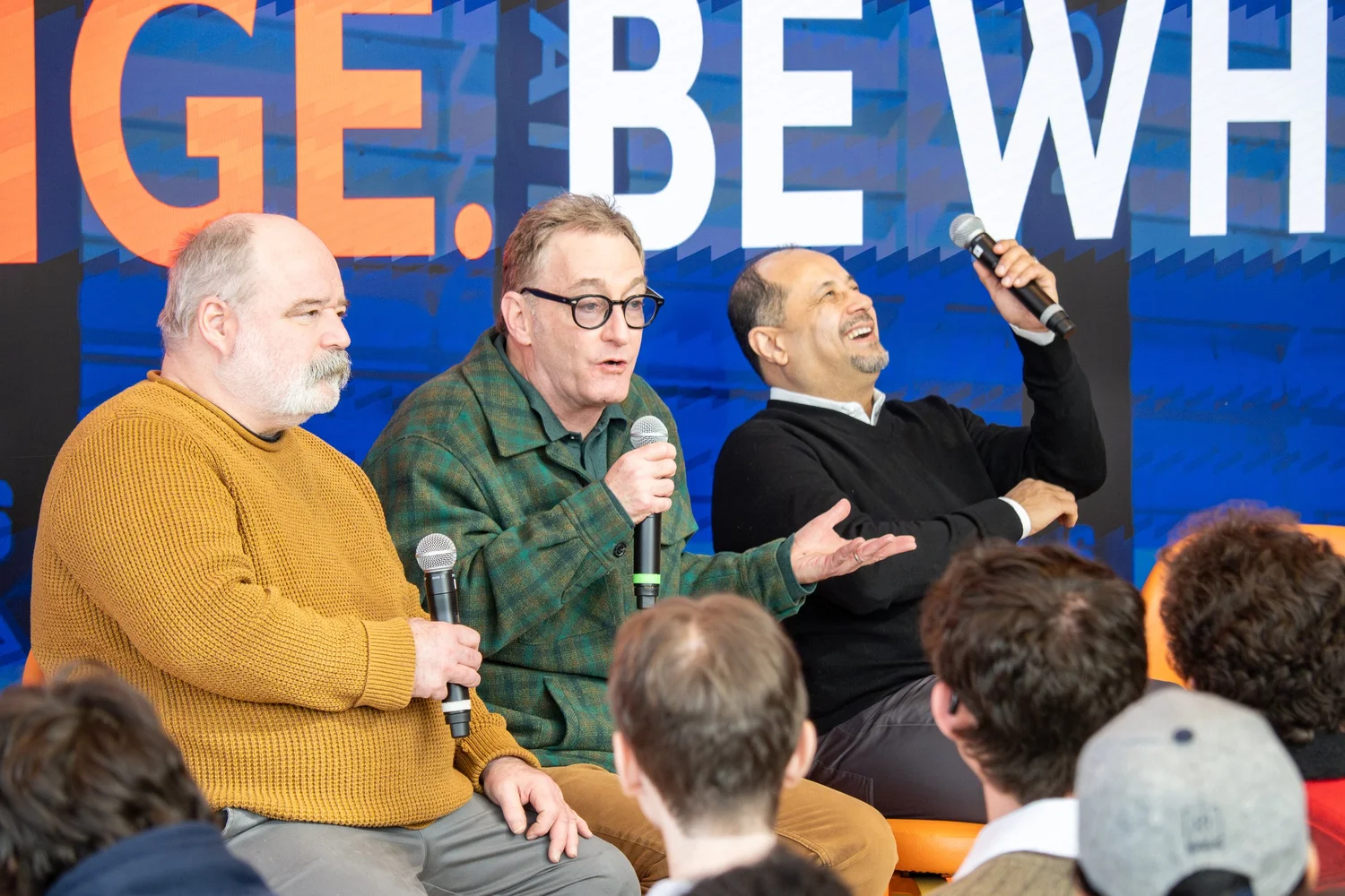 Animated panel discussion with speakers engaging a full audience — conference and corporate event photography.