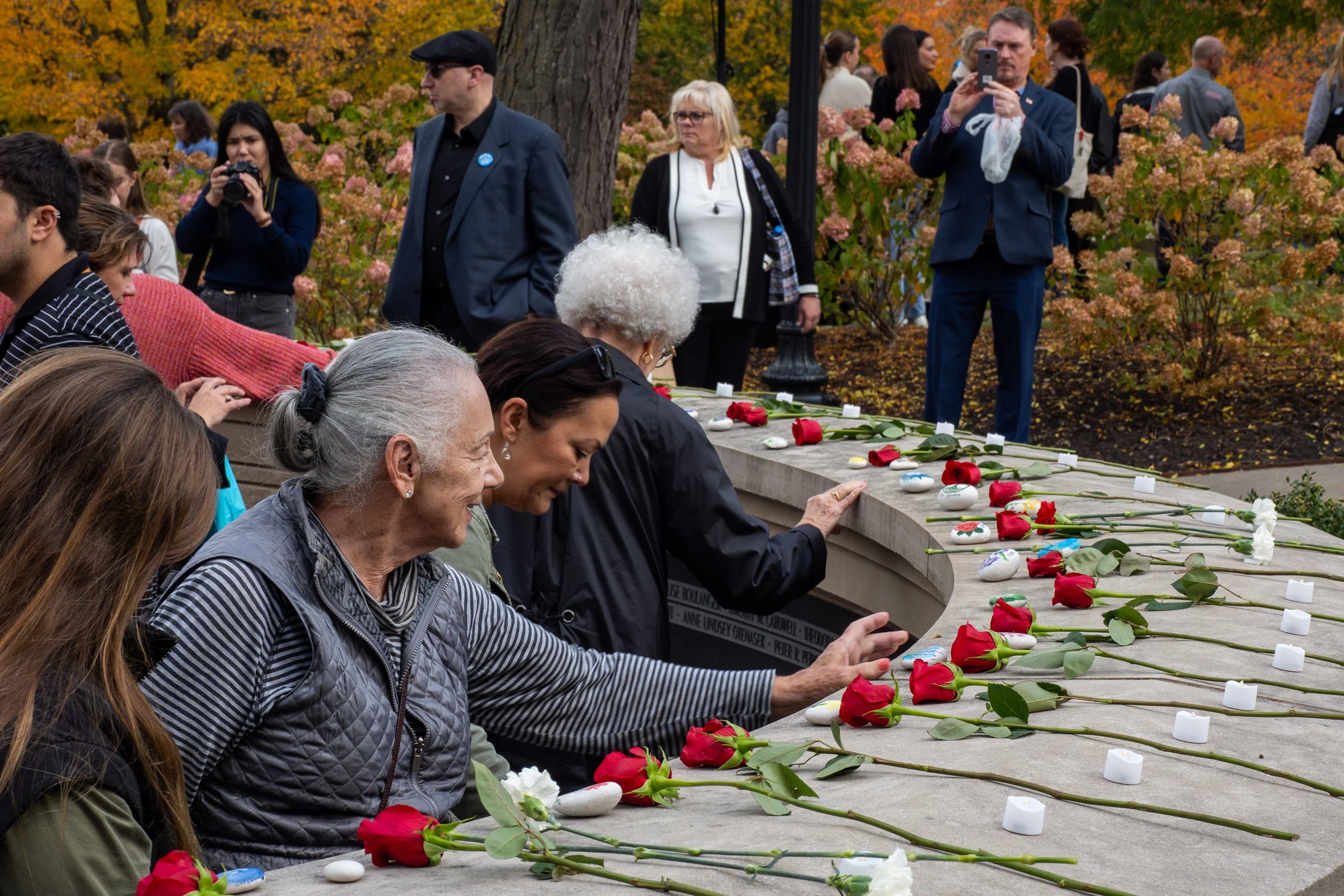 Community memorial placing roses