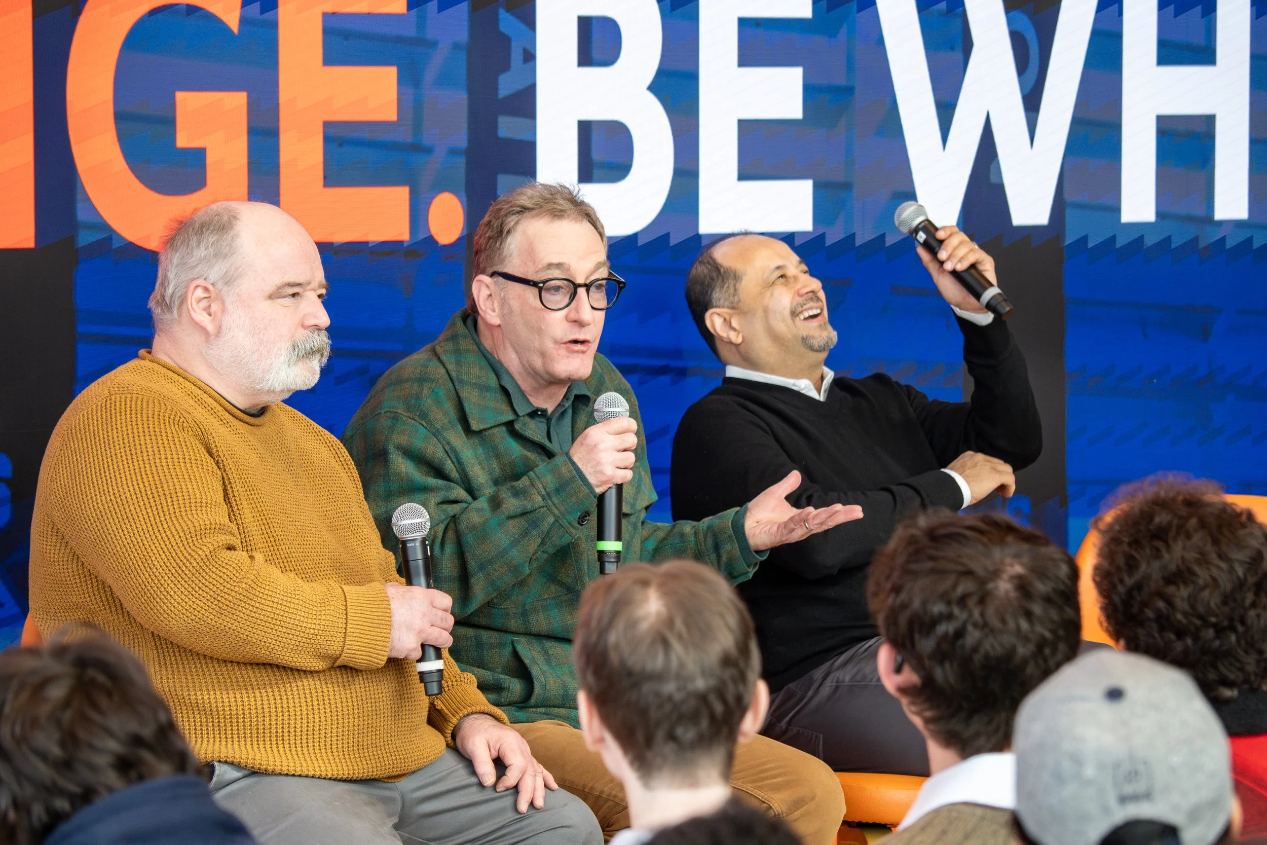 Panelists speaking on stage in Syracuse
