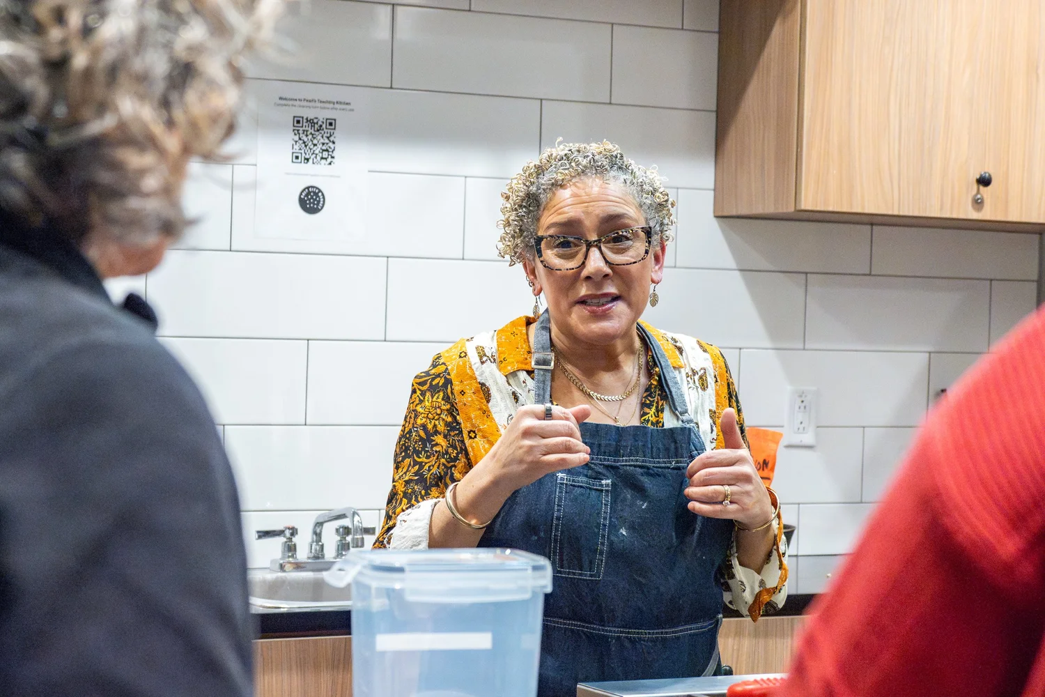Chef teaching a hands-on cooking class in a community kitchen — workshop event photography, Syracuse NY.