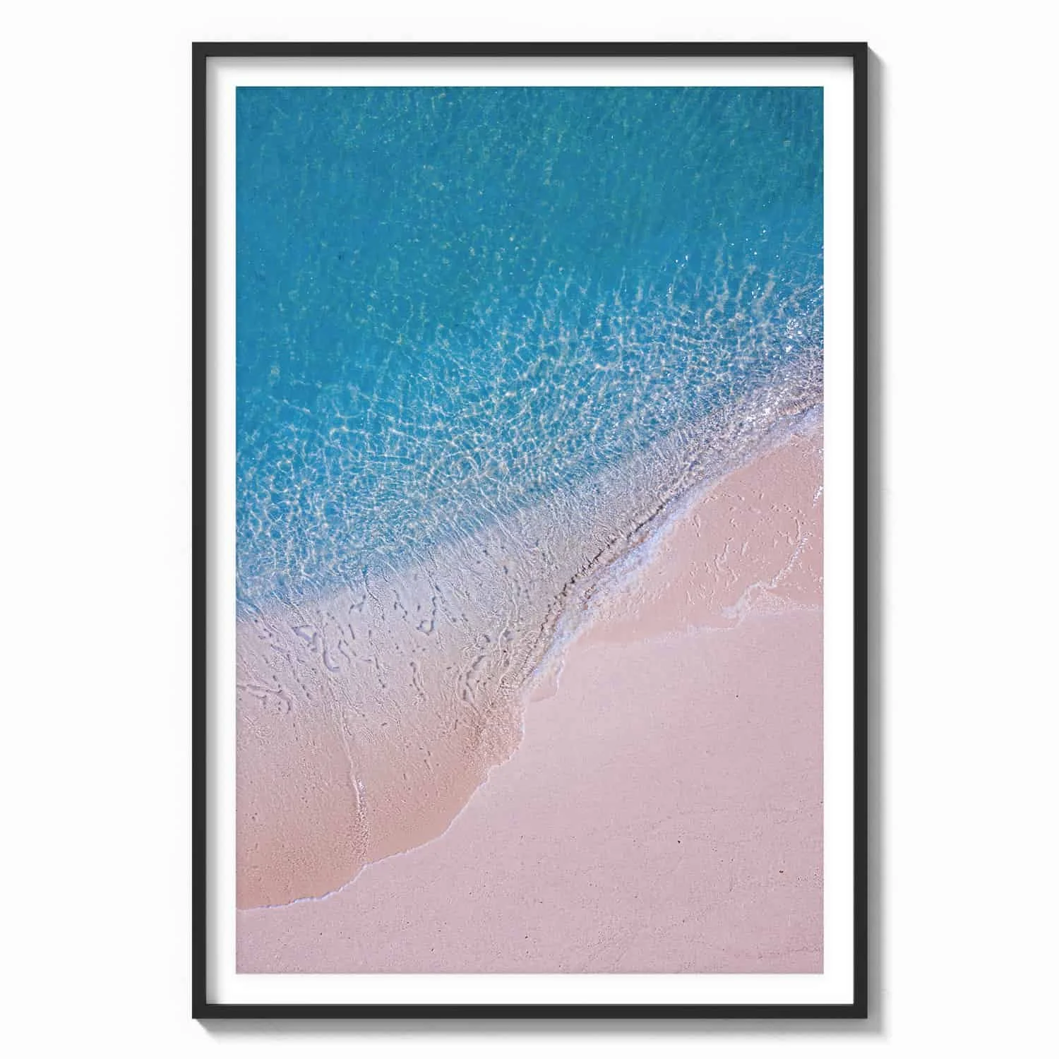 tourquoise waters and pink sands beach scene aerial view with black wood frame