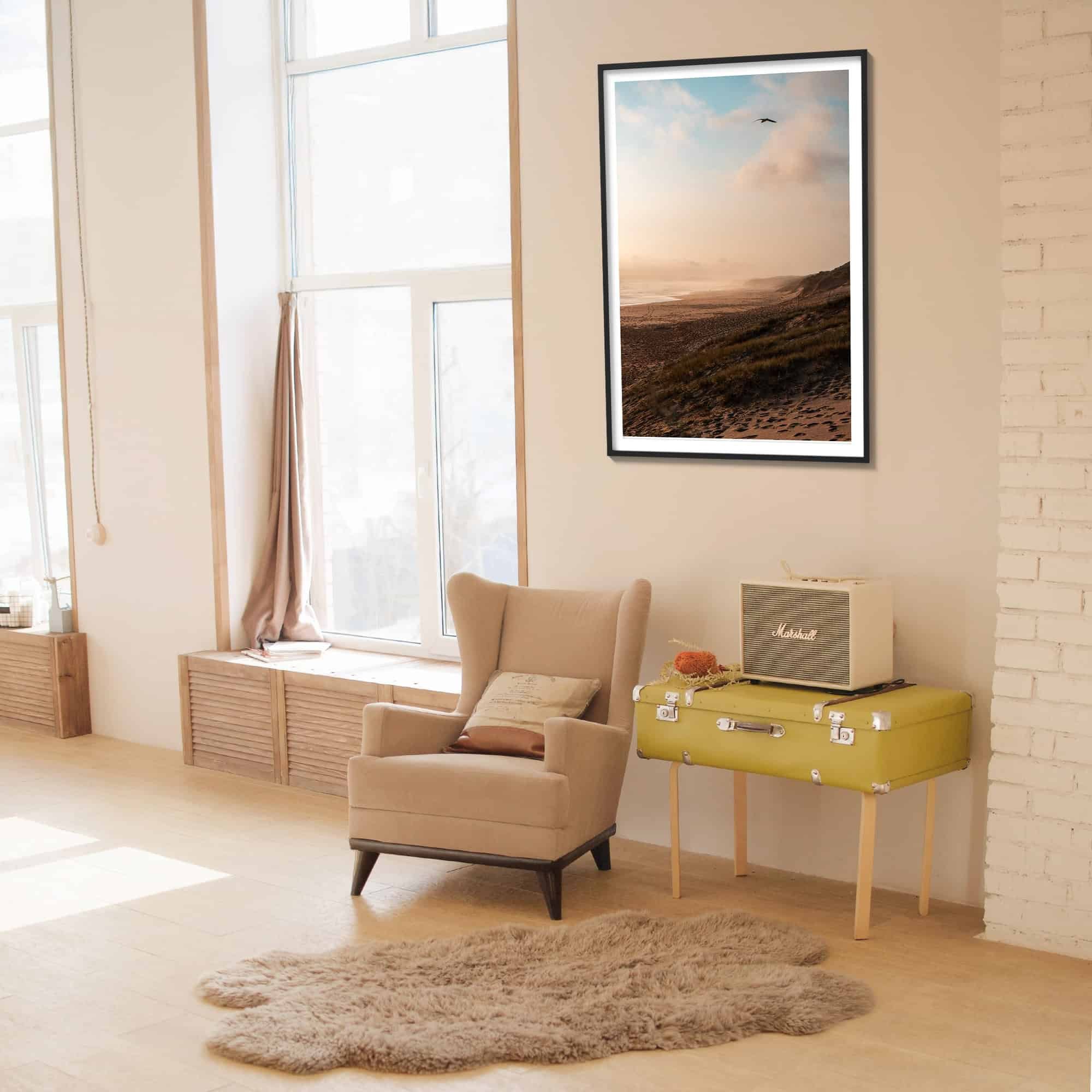 rugged beach scene print hung in living room with black wood frame.