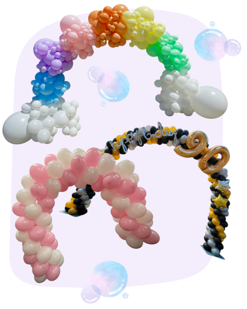Colorful balloon sculptures shaped like a rainbow and a unicorn with birthday-themed decorations, including small stars and a "Happy Birthday" banner.