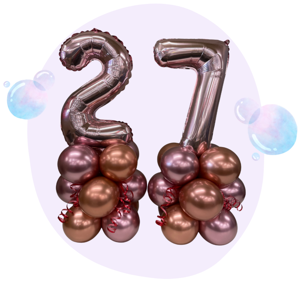 Number balloons 2 and 7 with pink and bronze balloons at the base, celebrating a 27th birthday or anniversary.
