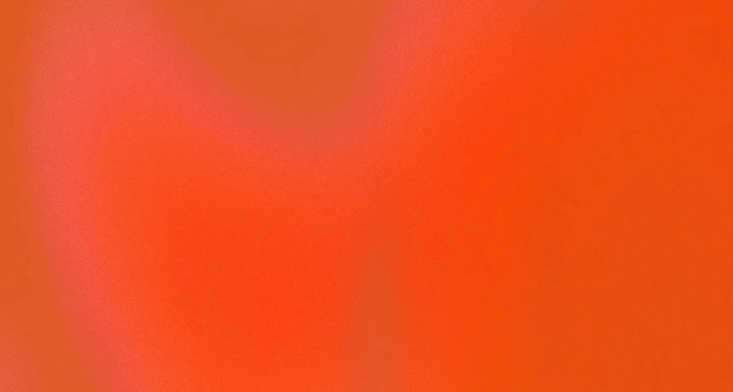 A blurry, orange-colored background with no distinctive objects or features.