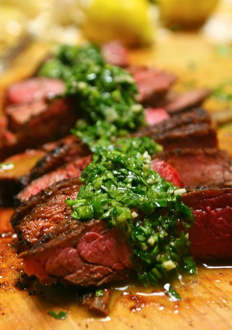 Wood-fired skirt steak with chimichurri close-up served by private chef in Aruba villa.