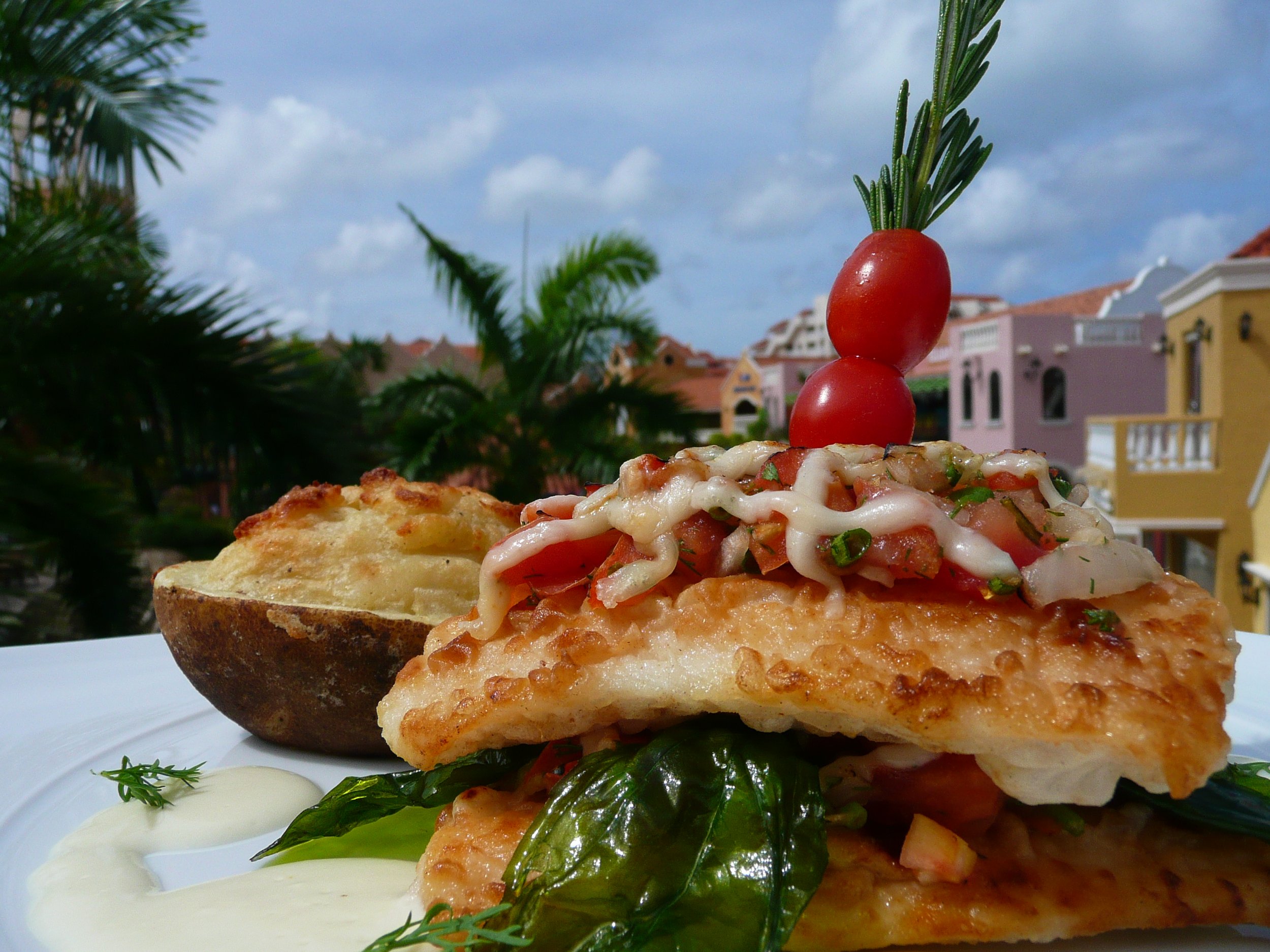 Caribbean grouper Creole prepared by private chef in Aruba villa dining setting.