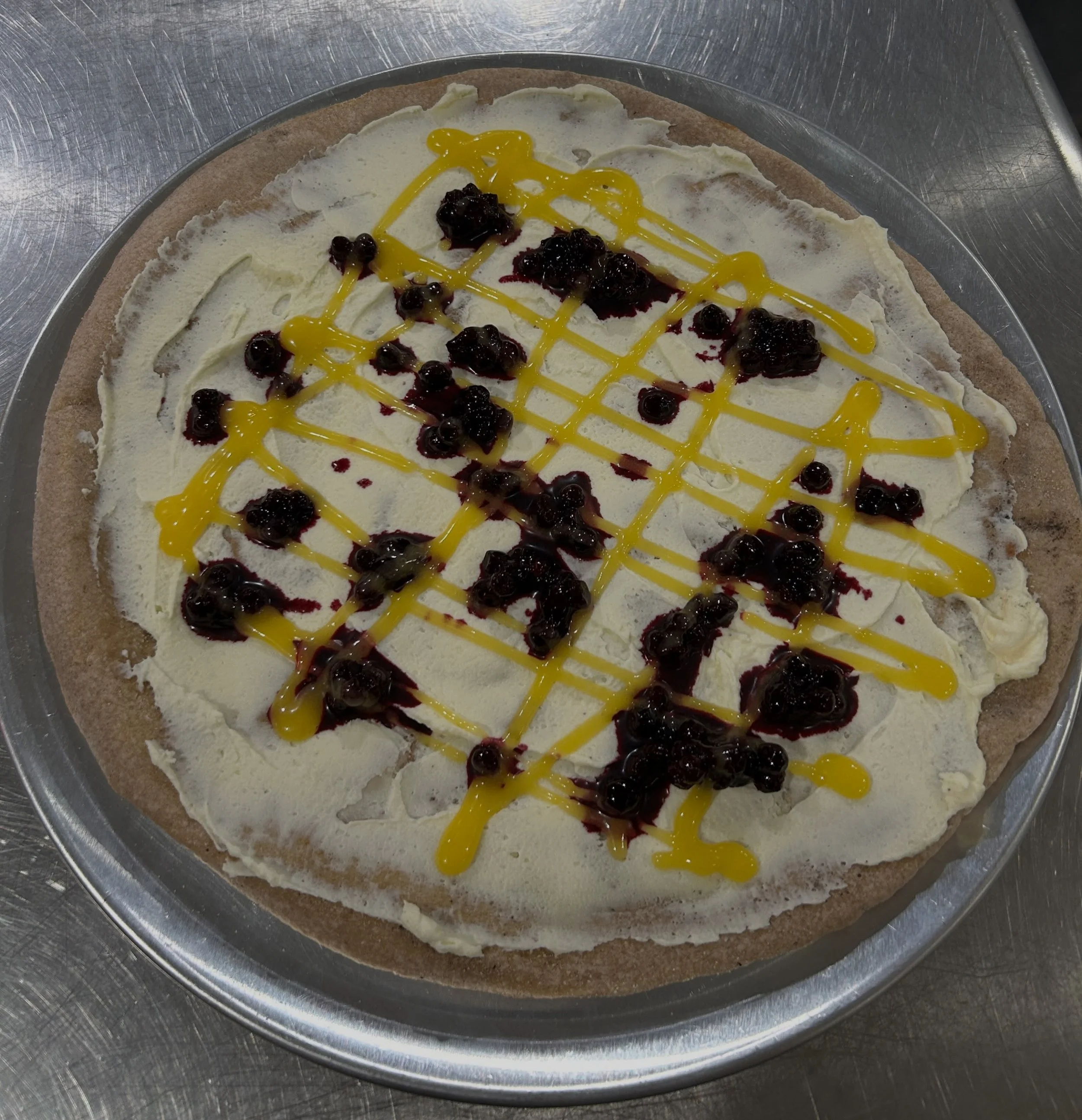 It&rsquo;s July and we have a tasty dessert pizza for #intothelight a annual fundraiser for @findingourvoicesmaine 

Mascarpone cream, wild Maine blueberry sauce and lemon curd drizzle!

Our new AC is running so come cool off and let us cook for you 