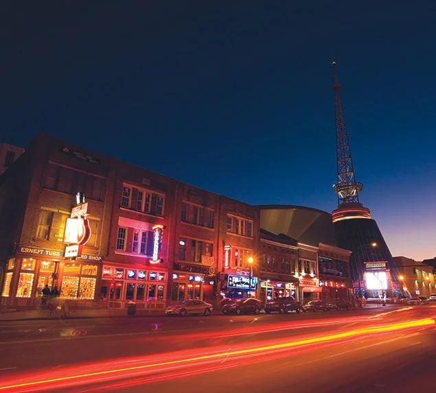 Downtown Nashville Broadway at night with neon lights and city skyline, a popular filming location for film and video production in Nashville TN