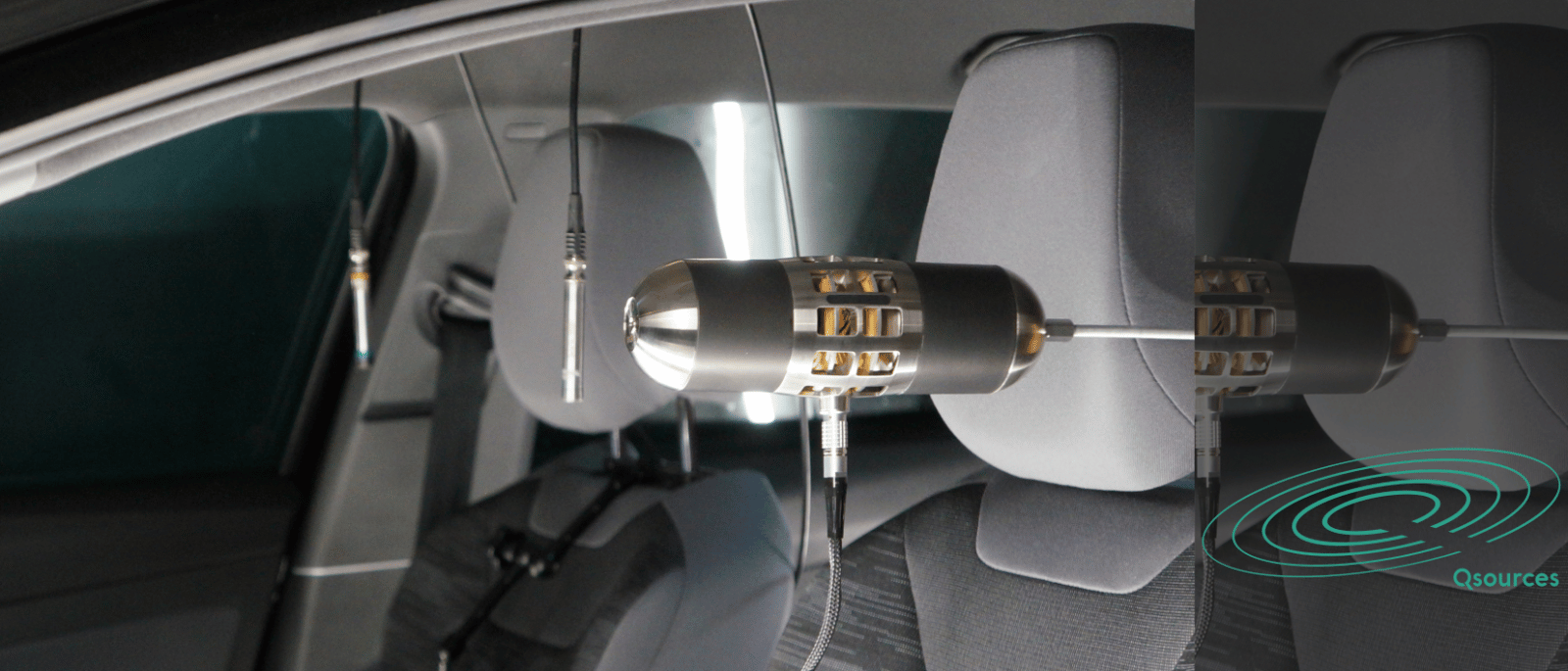 Qmed compact volume source for acoustic excitation and transfer function testing in a vehicle cabin