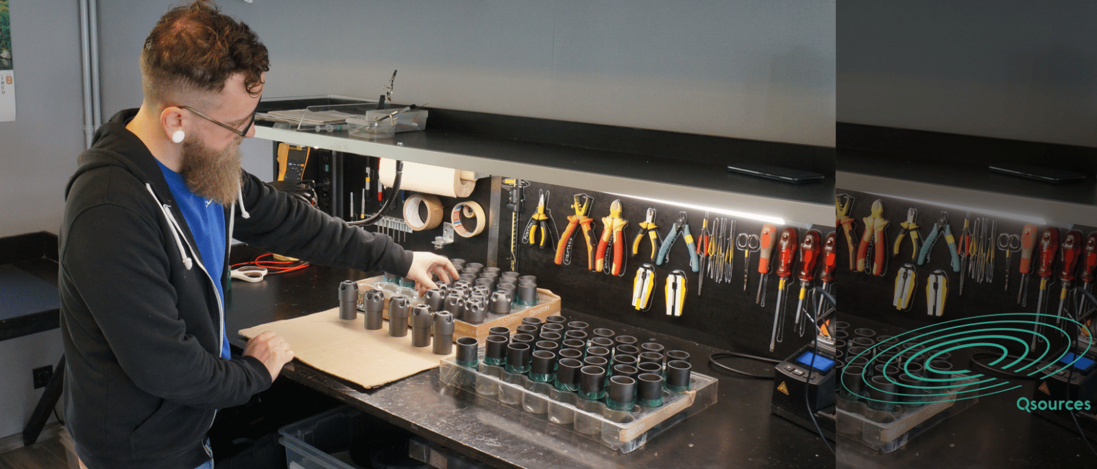 Qsources production workspace preparing components for excitation equipment