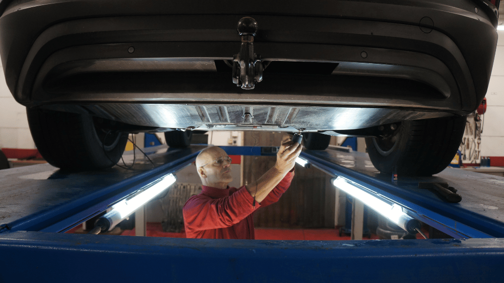 Qsources engineer performing noise and vibration measurements on a vehicle