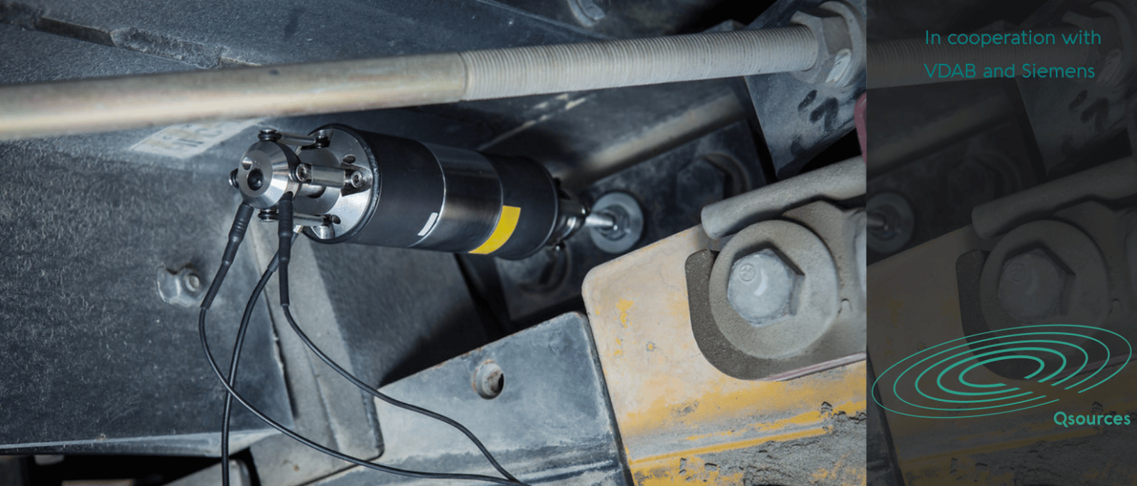 Qtmp thumper shaker mounted on machinery for low-frequency structural excitation in tight access locations