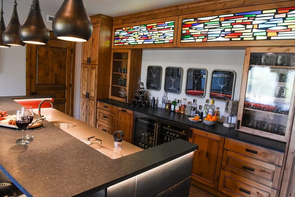 Salvaged sidelites from the original front door repurposed and backlit over the bar