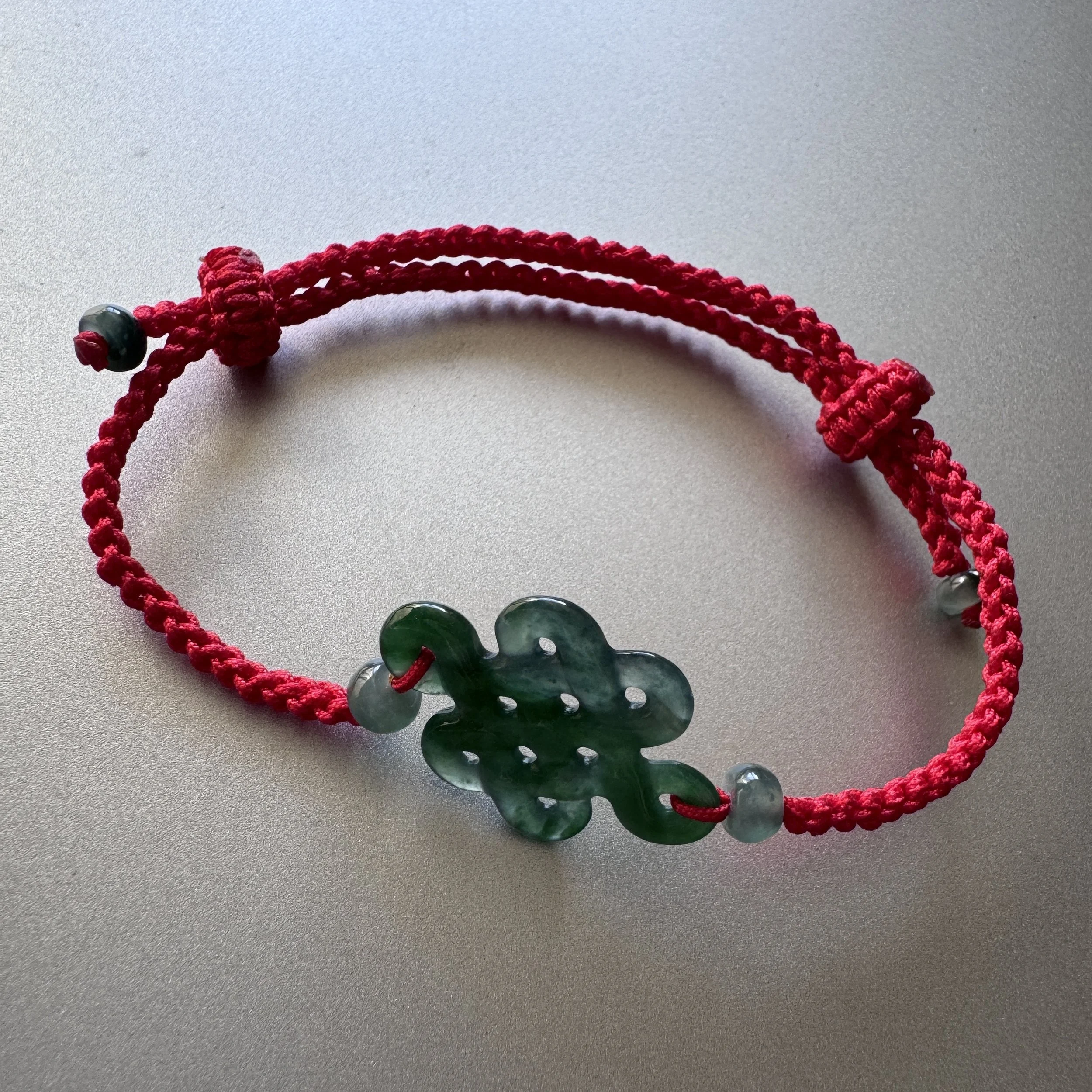 Jade charm bracelet - Hand-Carved Natural Myanmar  icy Green Jadeite "Endless Knot" red  Cord Bracelet