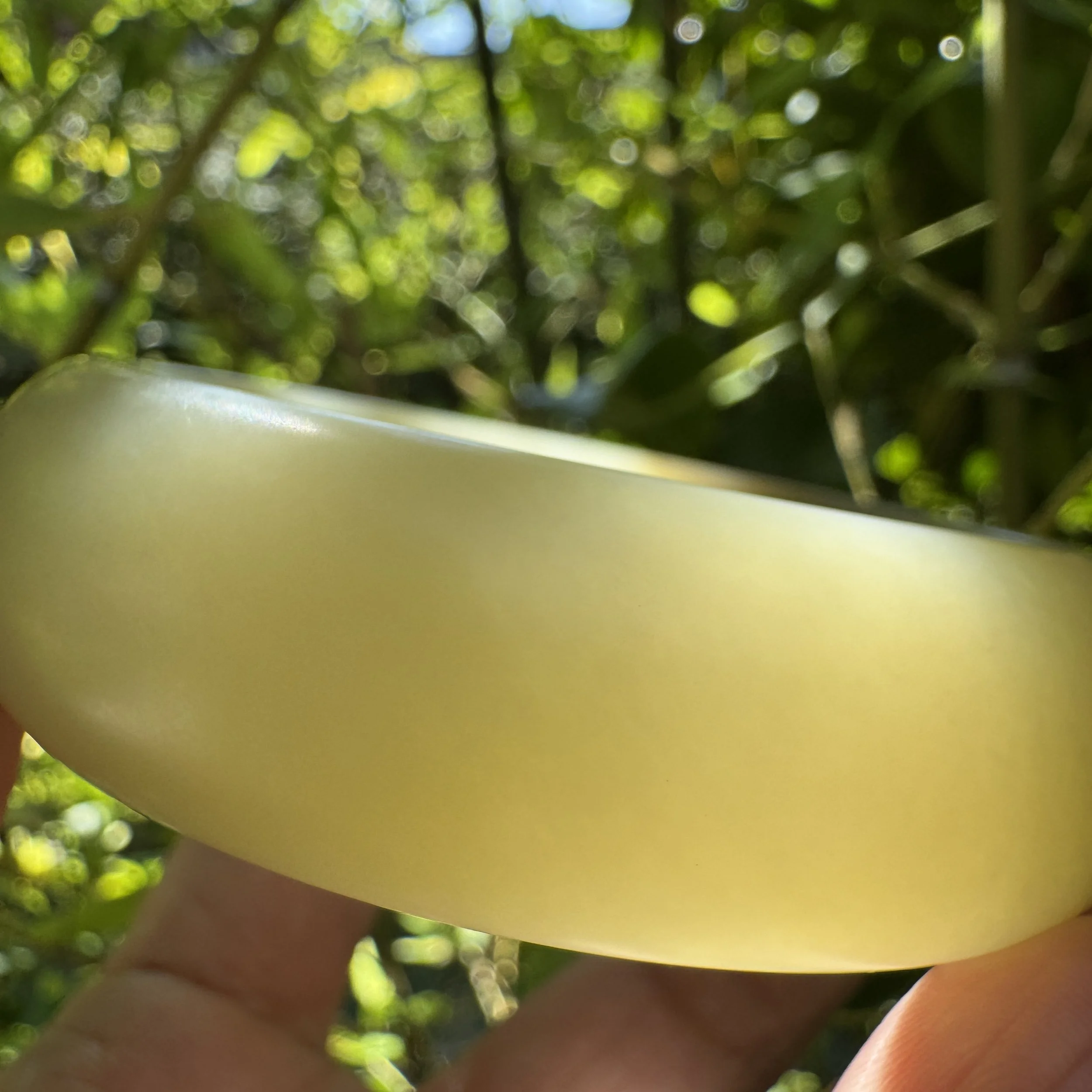 close-up of fine-grained Hetian nephrite jade with natural golden brown sugar tones