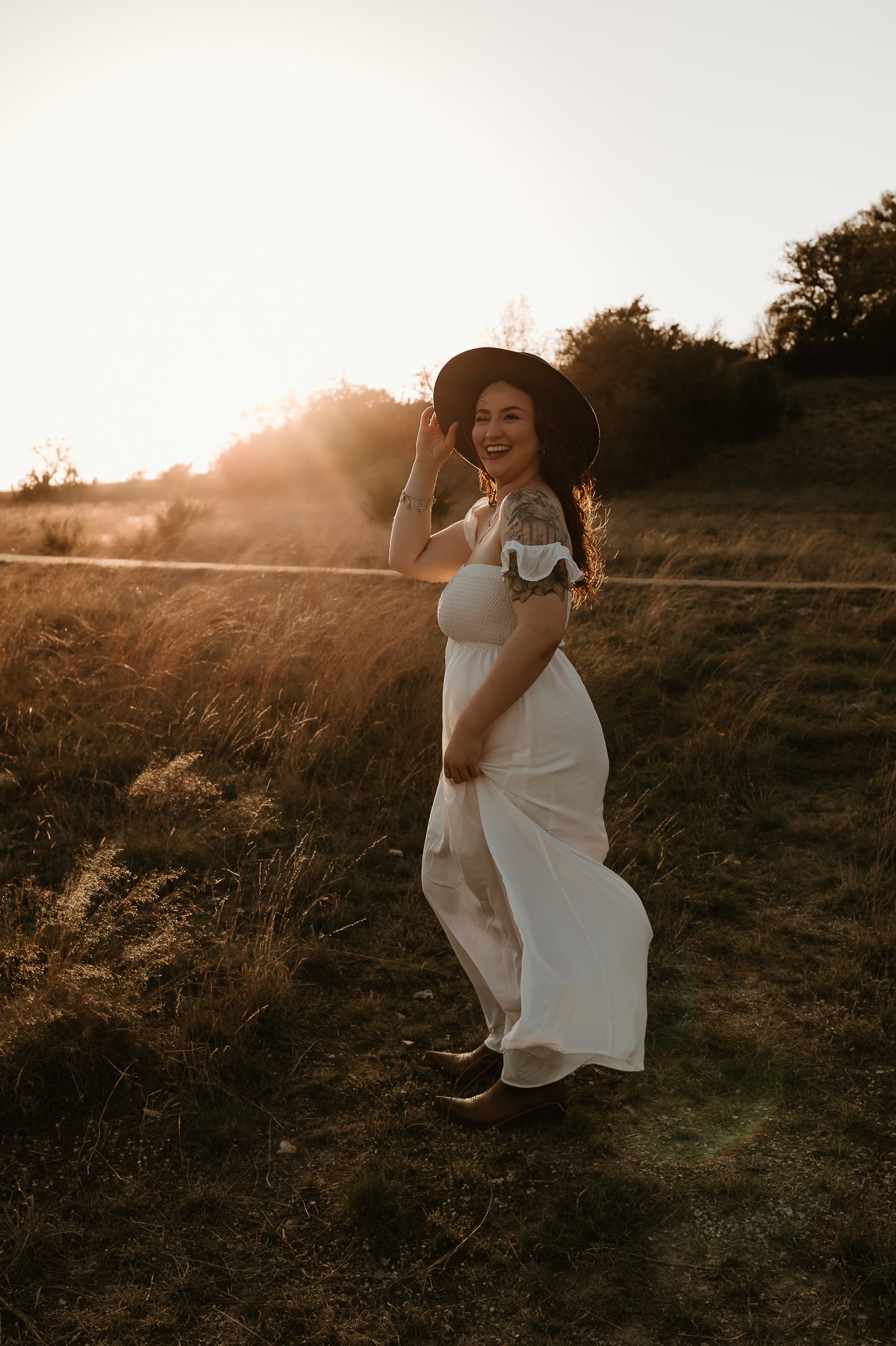 Captured mid-spin, a senior twirls in their flowy Western-inspired dress, radiating joy and confidence.