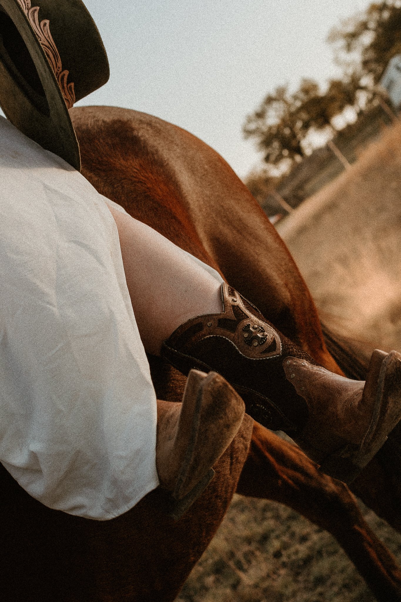 A senior runs through an open field, boots kicking up dust, with the Texas sky stretching endlessly behind them.