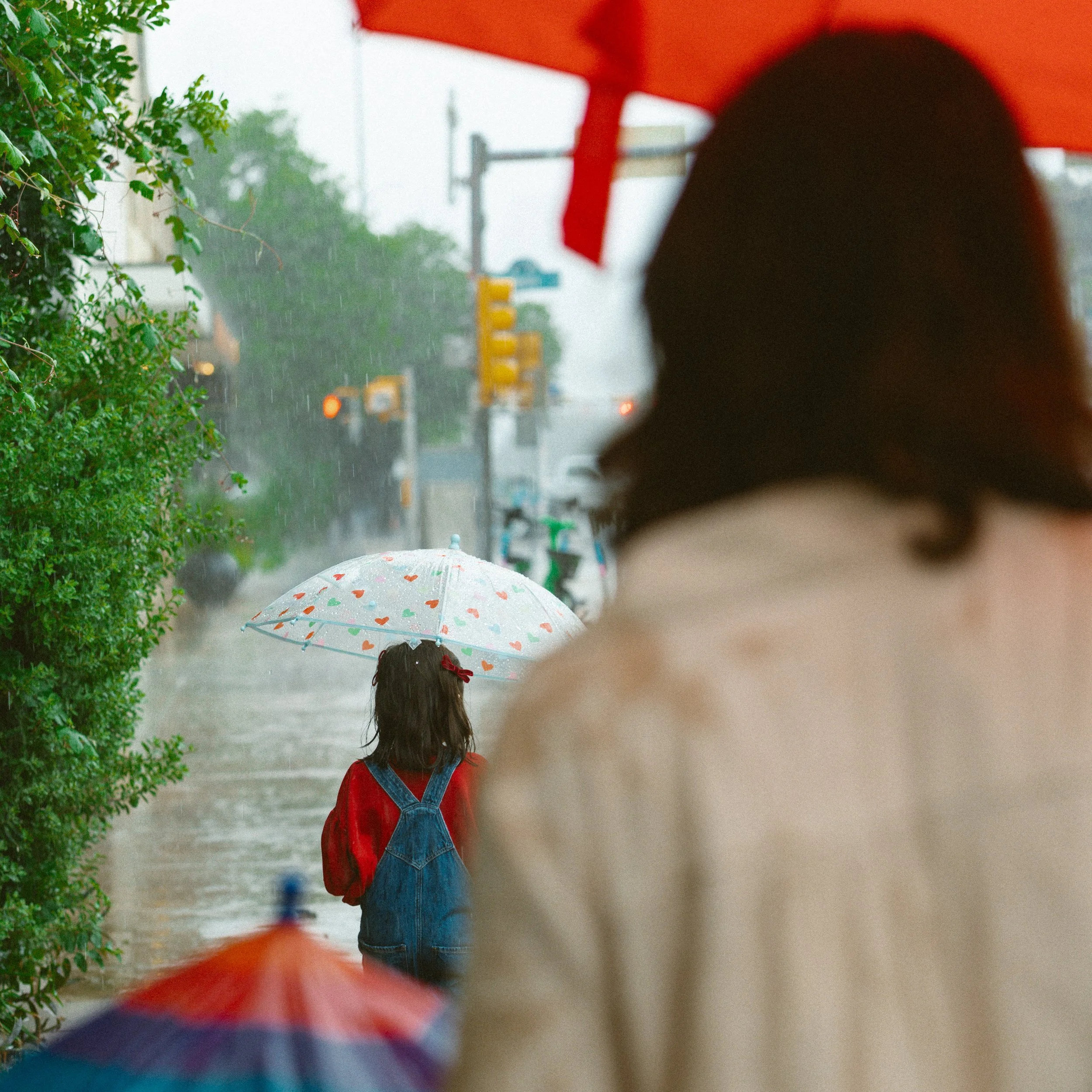 Family in South Congress- Austin, Texas walking with rainbow umbrellas