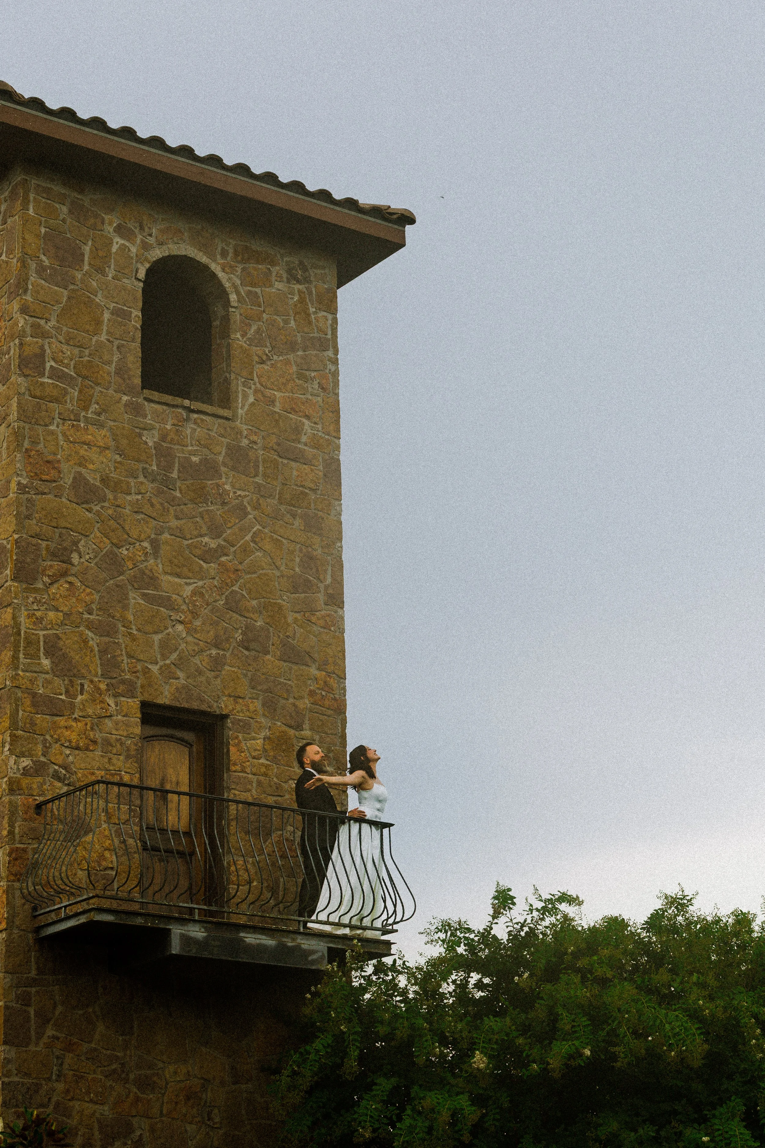 Bride and Groom on balcony at The Ma Mansion, Hill Country, Texas