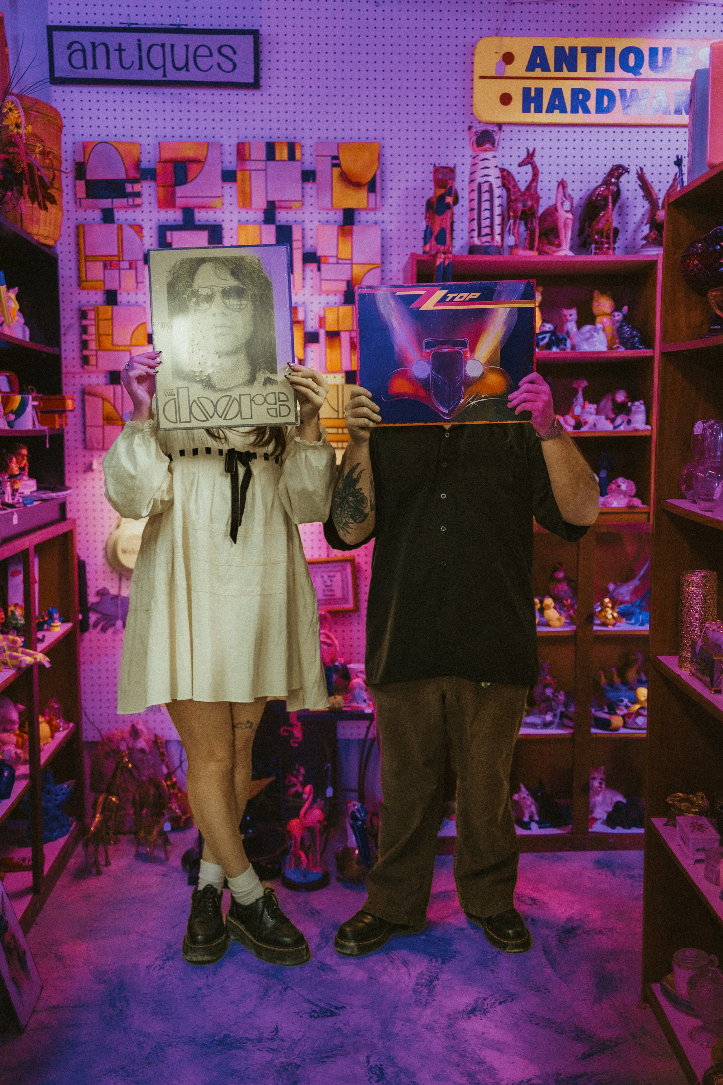 A couple holding records over their faces at an atnique shop in Salado, Texas