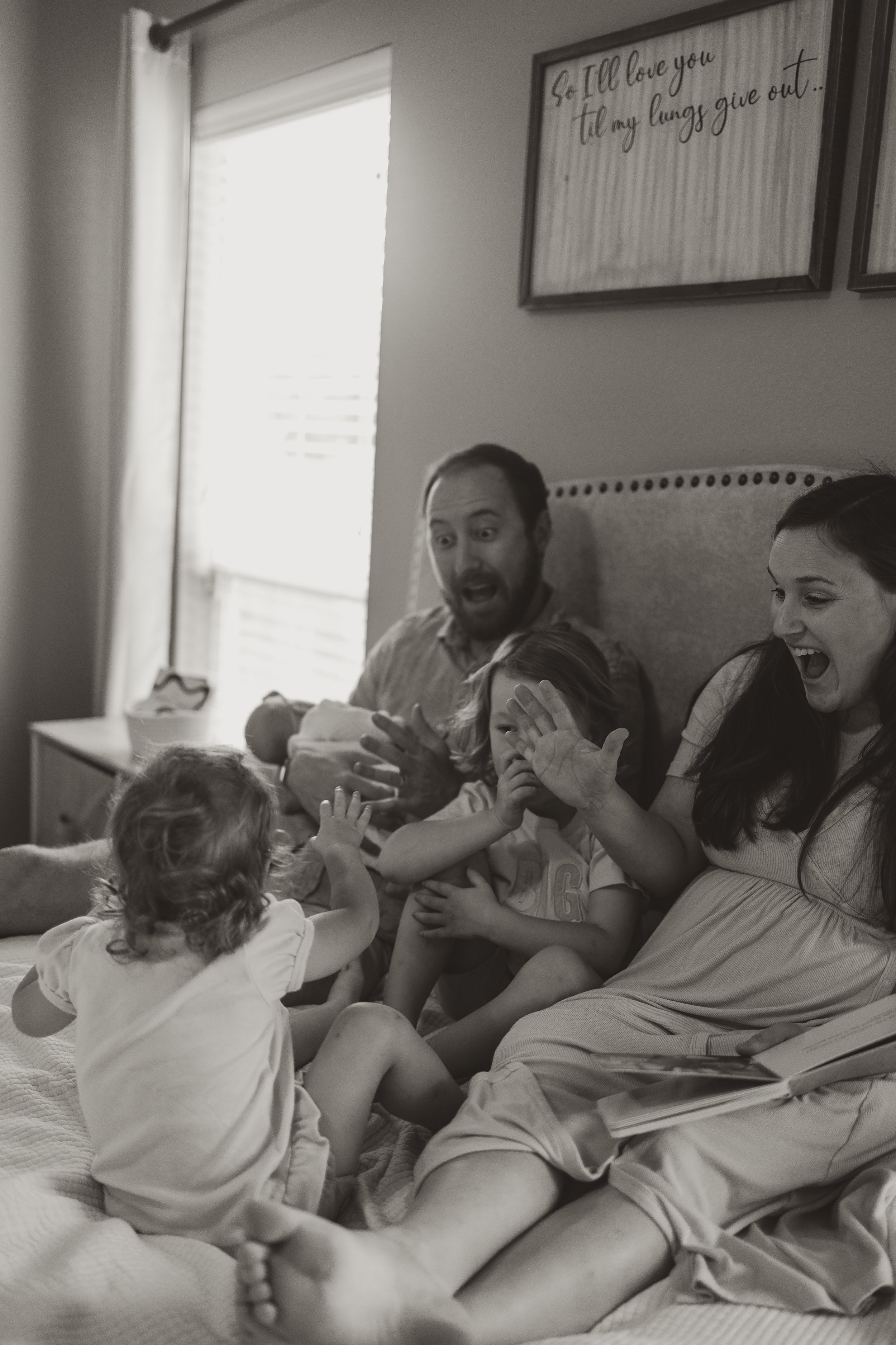 family reading book together on bed