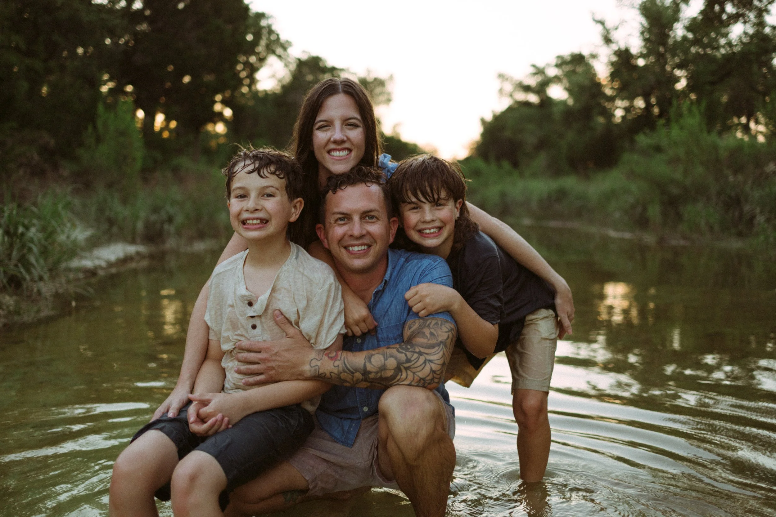 Children splashing and exploring during a creek family photography session