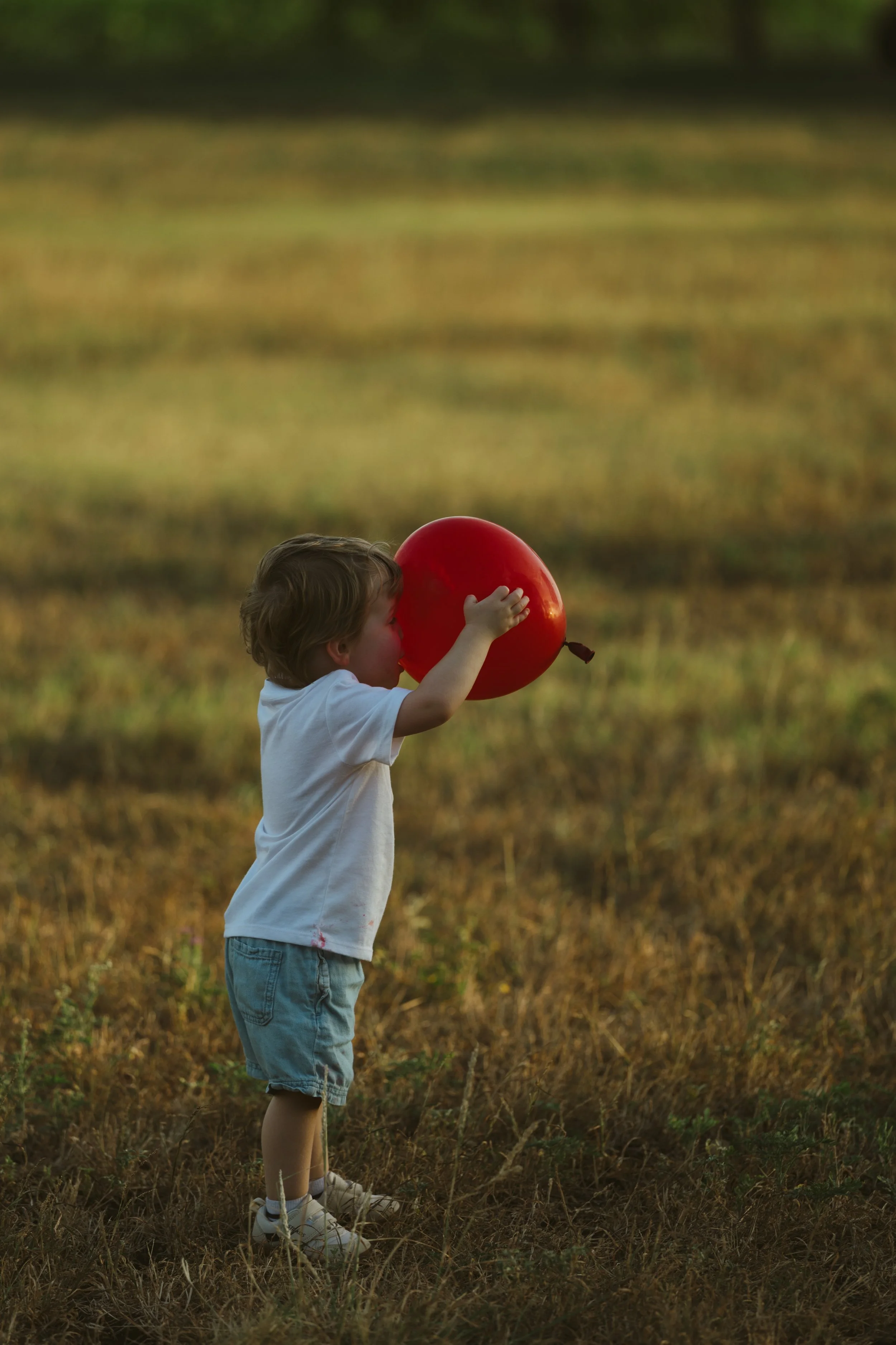 A child chasing after a red balloon in Salado, Texas
