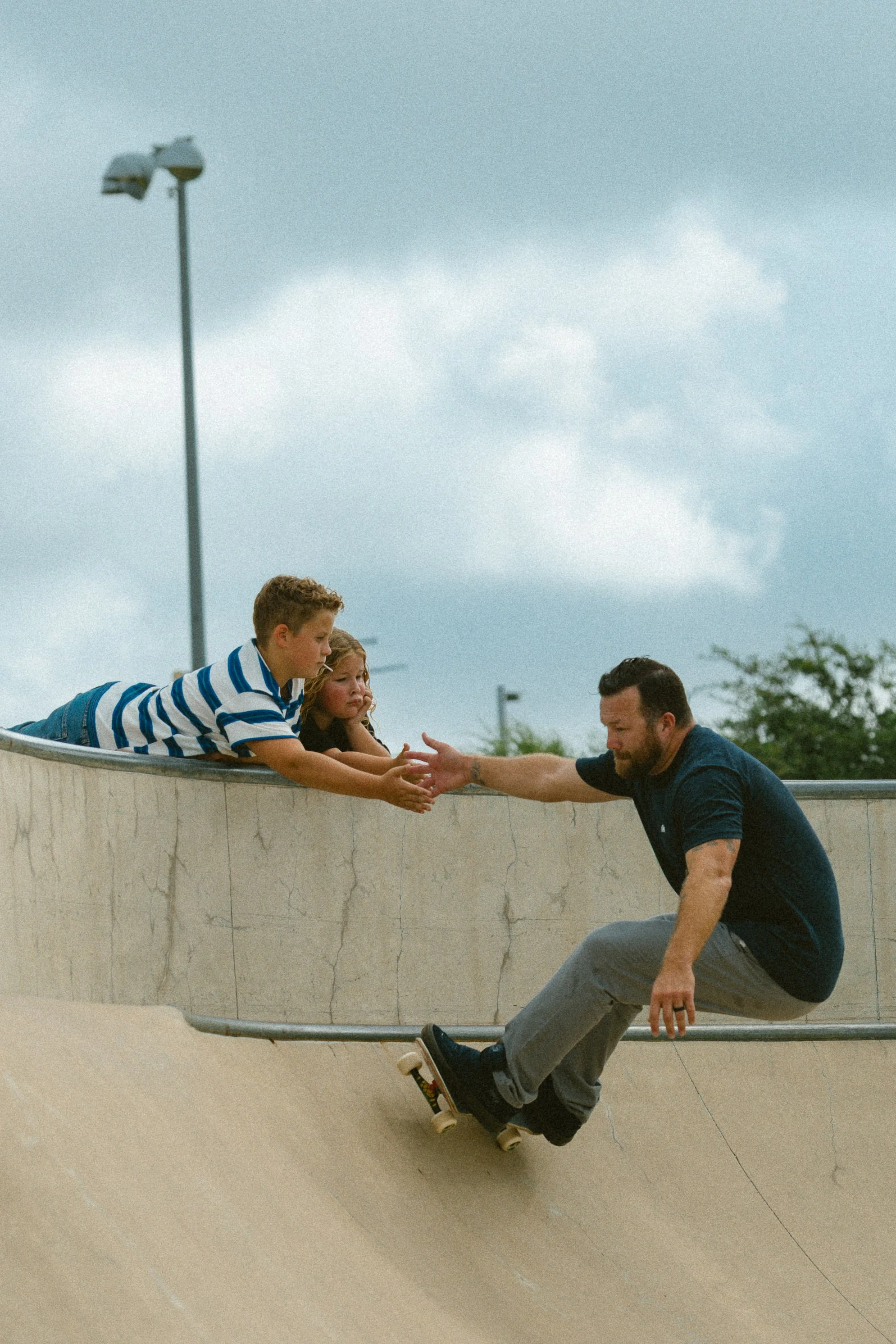 A dad high-fiving his son at skatepark in Pflugerville, Texas 