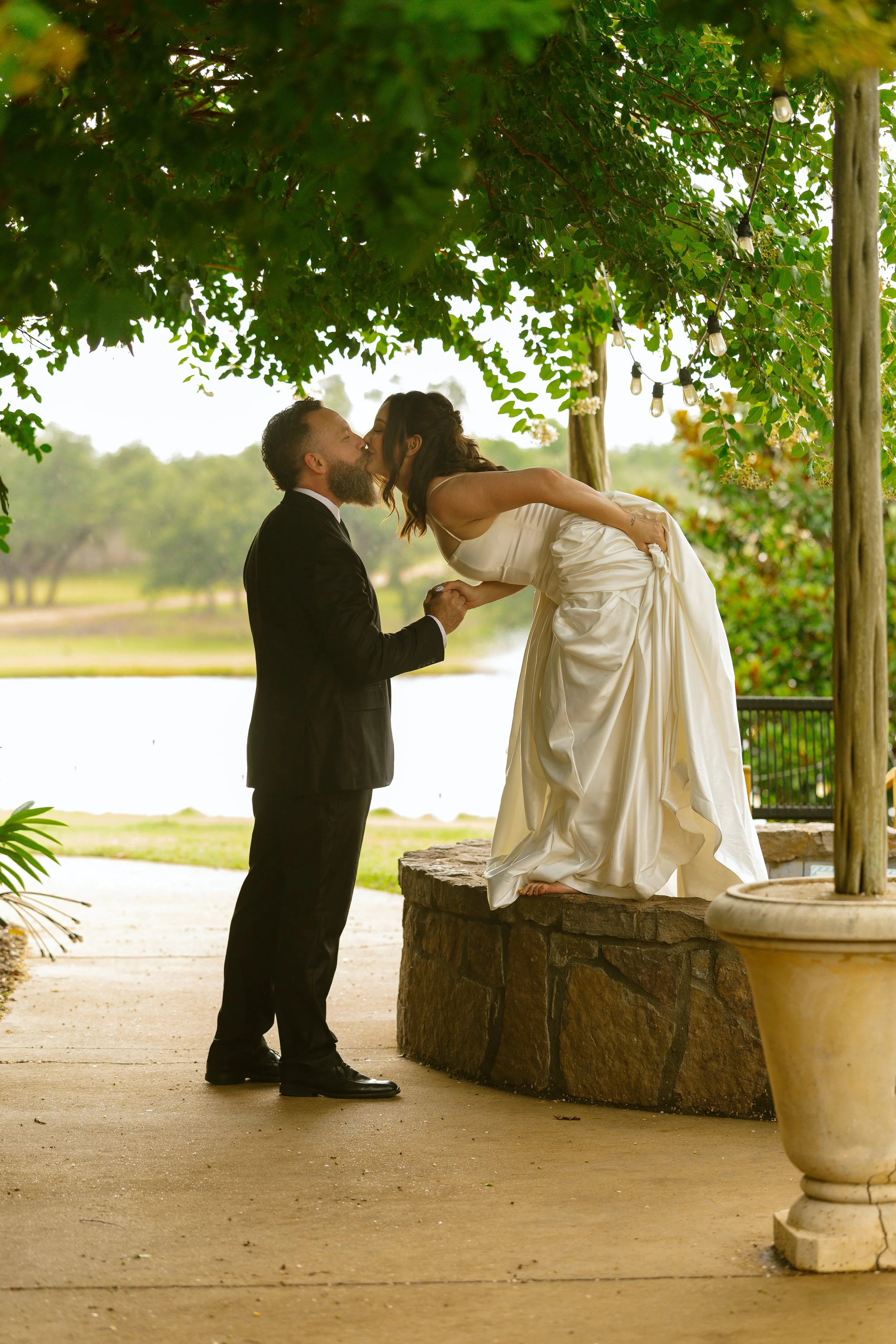 Bride laughing during playful cinematic wedding portraits in a field