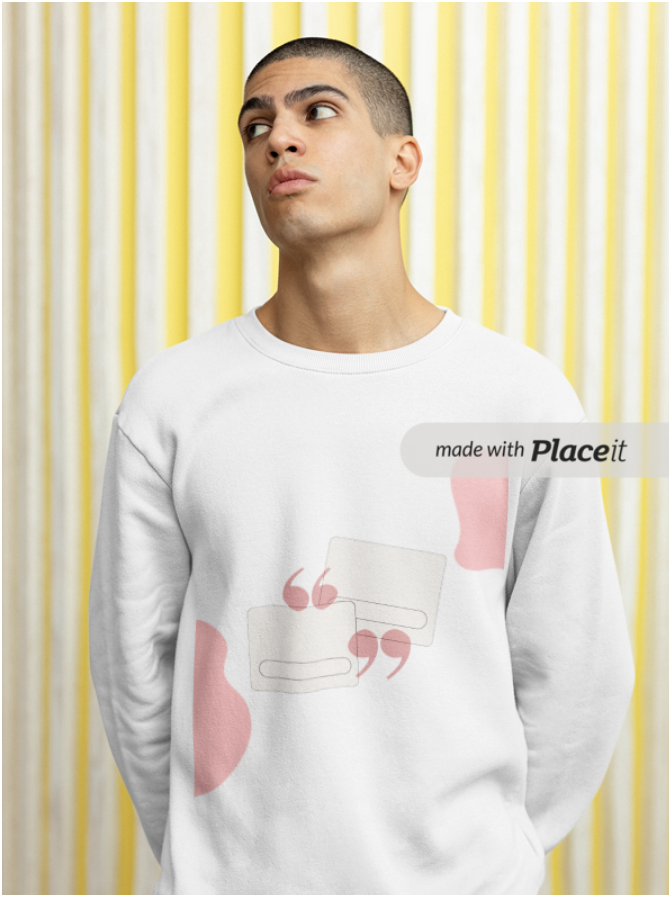 Young man with short hair wearing a white sweatshirt with a graphic design and pink accents, standing in front of a yellow and white striped background.