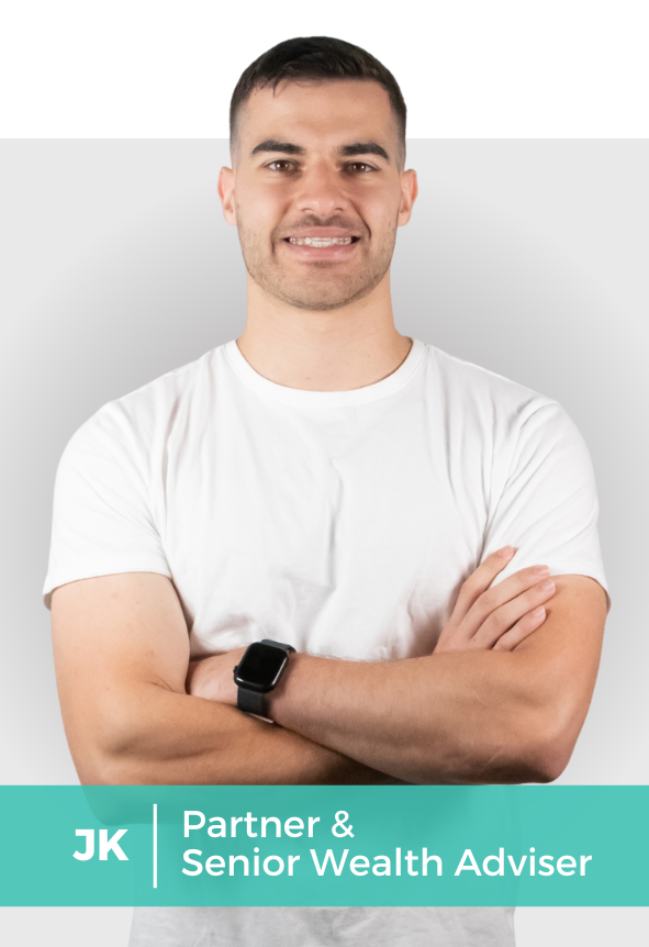 A young man with short dark hair and light skin, wearing a white t-shirt and a smartwatch, confidently smiling with arms crossed against a light gray background.